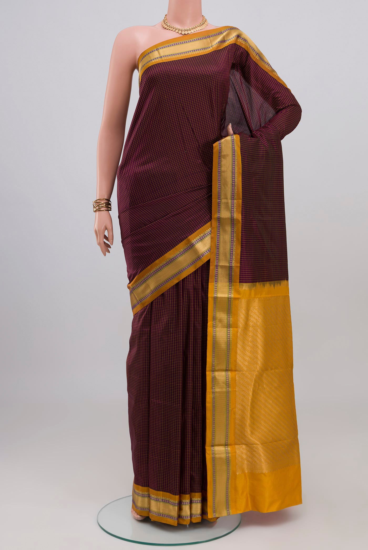Brown Narayanpet Silk Saree with Checked design on the body and Zari Border.  displayed on a mannequin