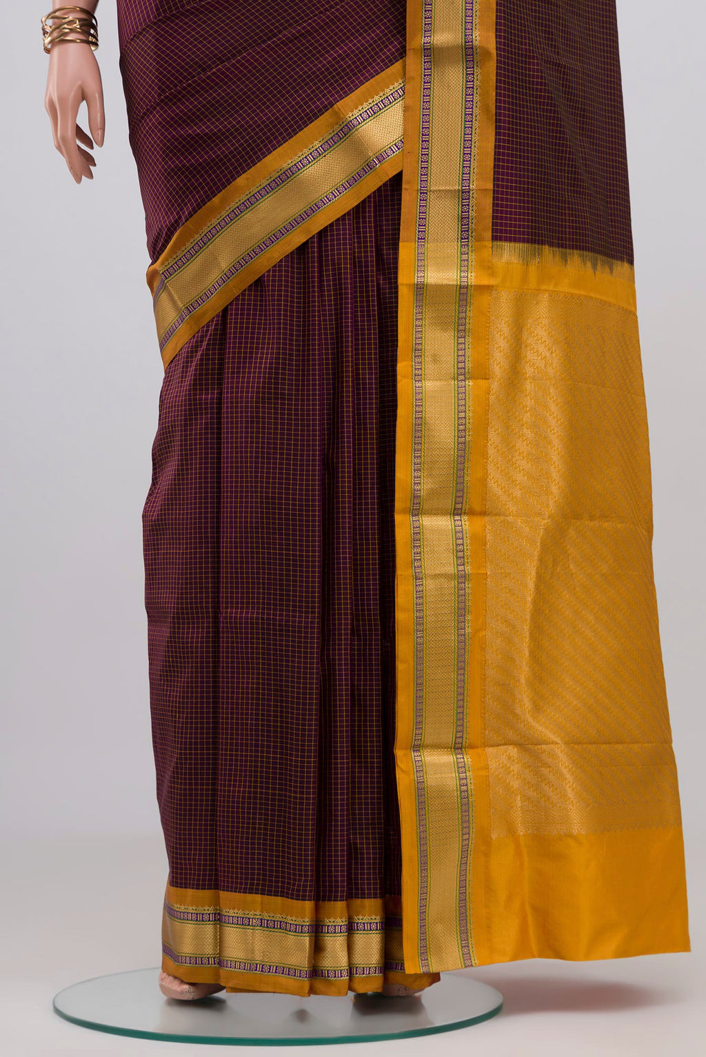 Pleats and pallu of Brown Narayanpet Silk Saree with Checked design on the body and Zari Border. 