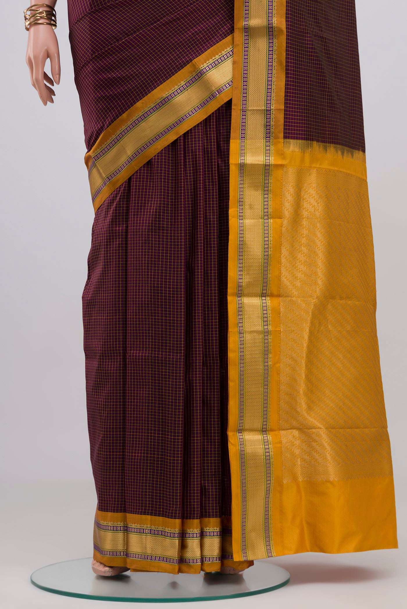 Pleats and pallu of Brown Narayanpet Silk Saree with Checked design on the body and Zari Border. 