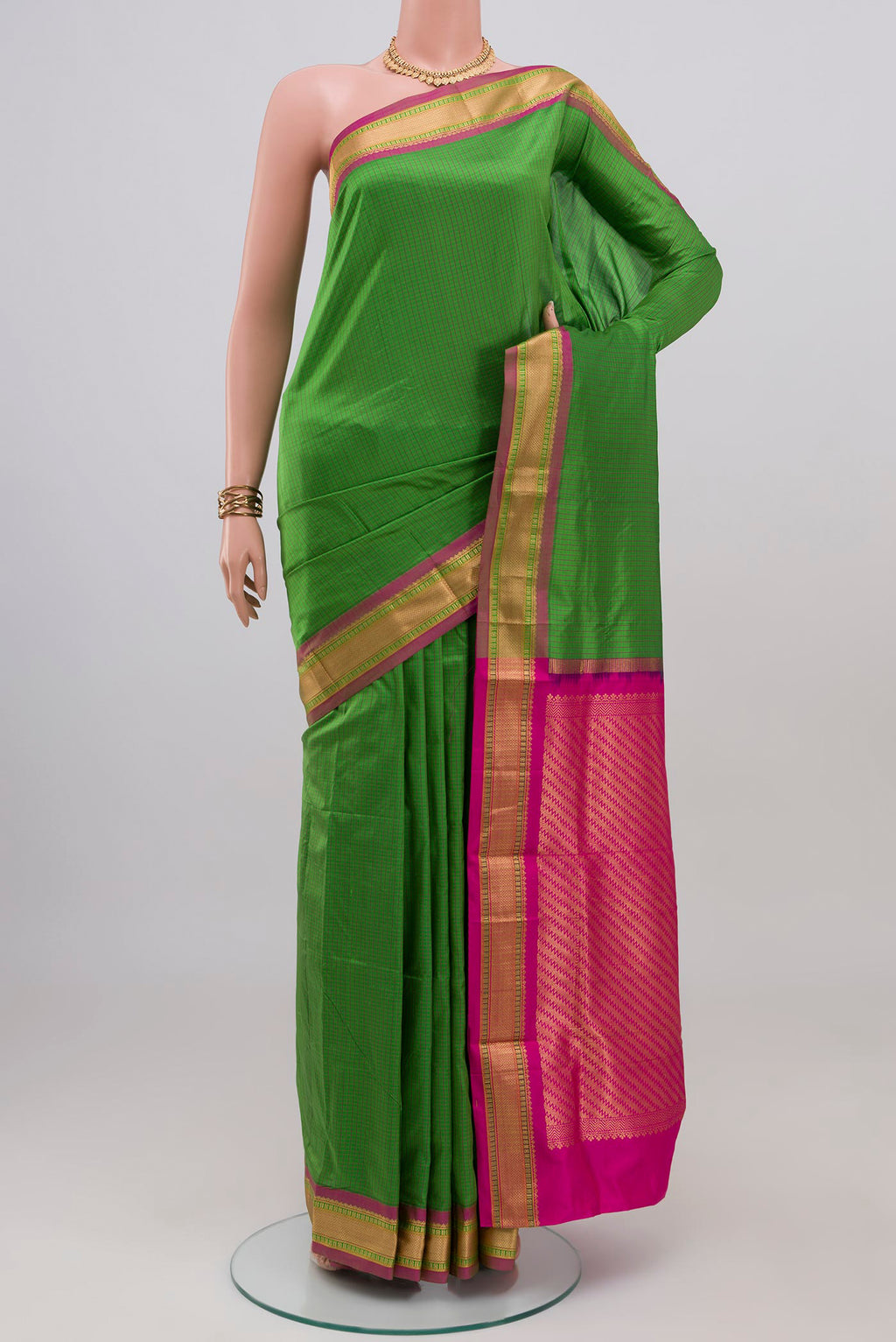Green Narayanpet Silk Saree with Checked design on the body and Zari Border.  displayed on a mannequin