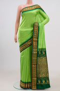 Parrot Green Bangalore Silk Saree with Zari Butta on the body and Zari Border.  displayed on a mannequin