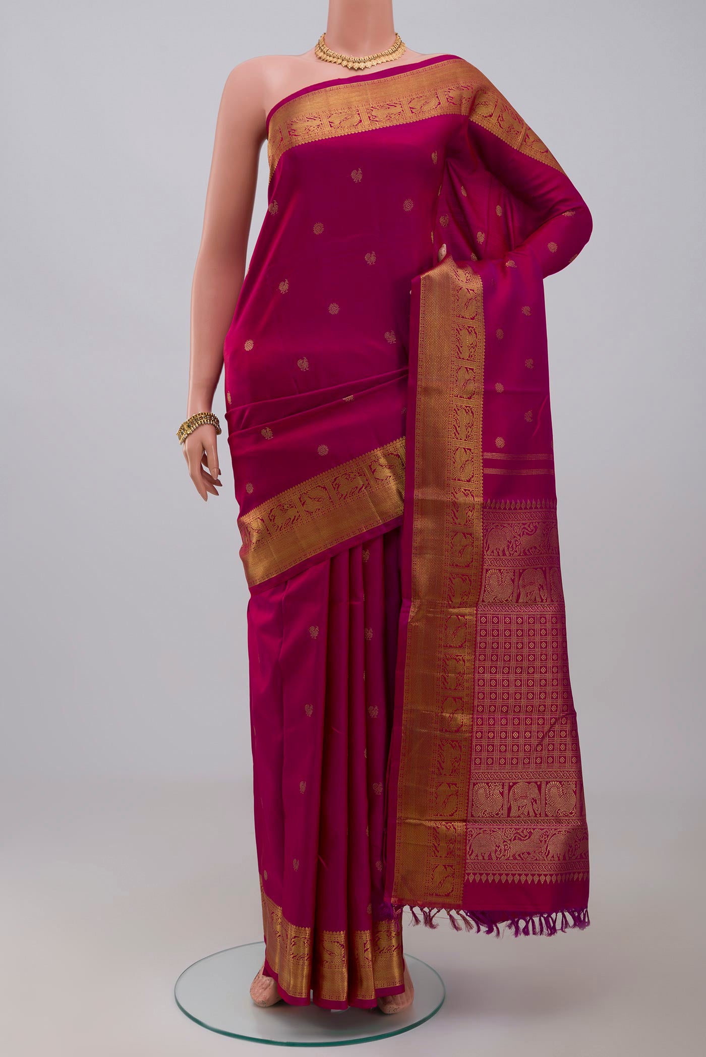 Pure Silk Pure Zari Pink Kanjivaram Saree with Zari Butta on the body and Zari Border.  displayed on a mannequin