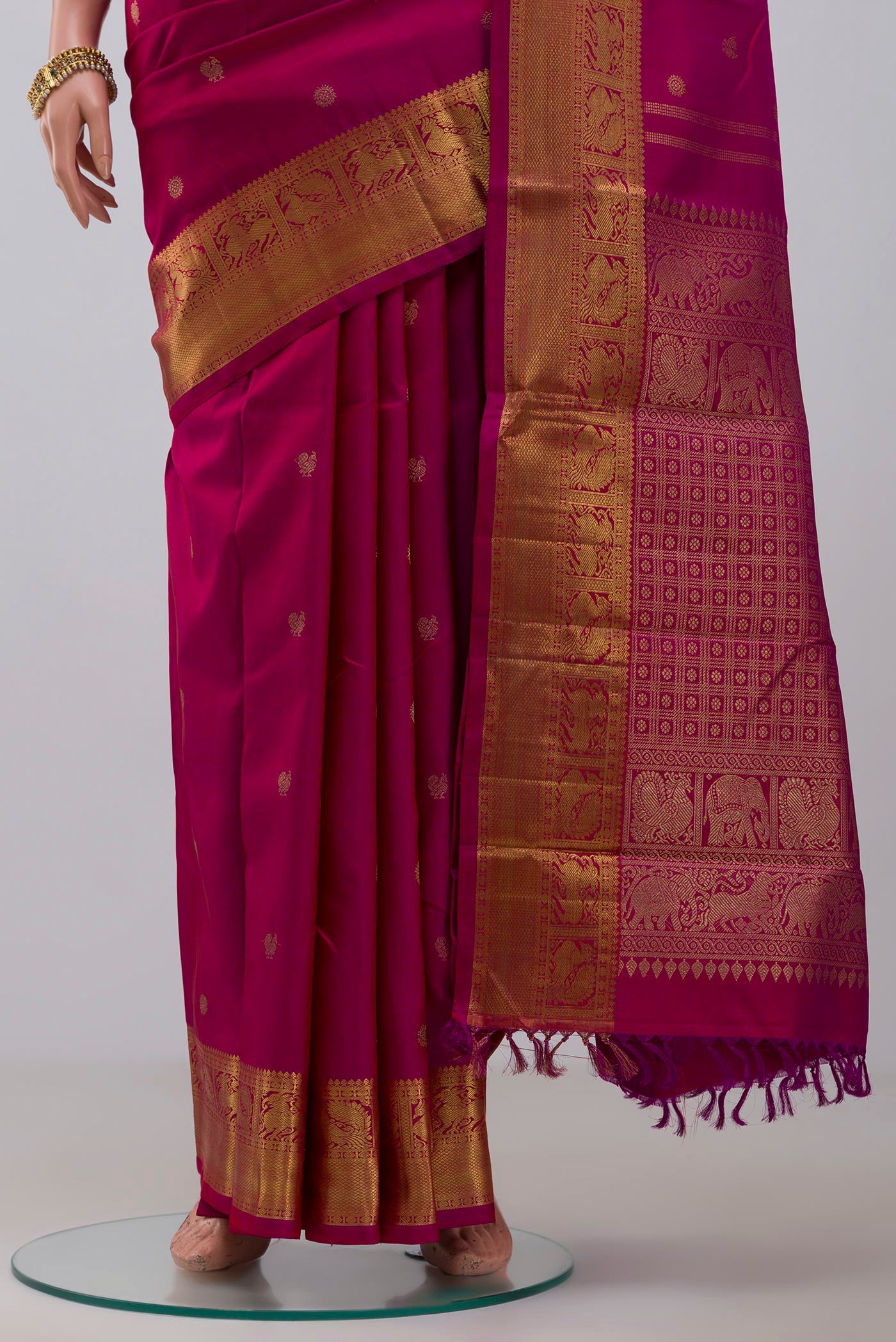 Pleats and pallu of Pure Silk Pure Zari Pink Kanjivaram Saree with Zari Butta on the body and Zari Border. 