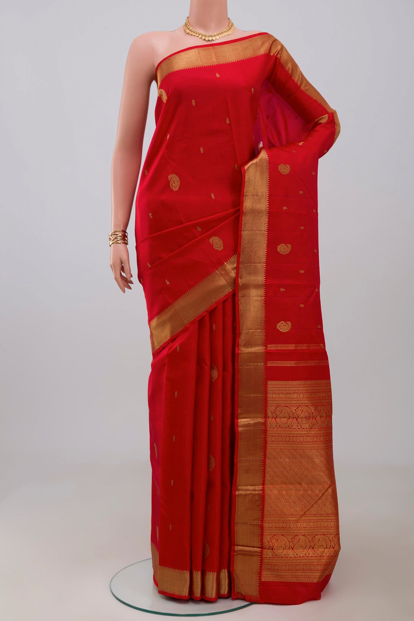 Pure Silk Pure Zari Red Kanchipuram Saree with Zari Butta on the body and Zari Border.  displayed on a mannequin
