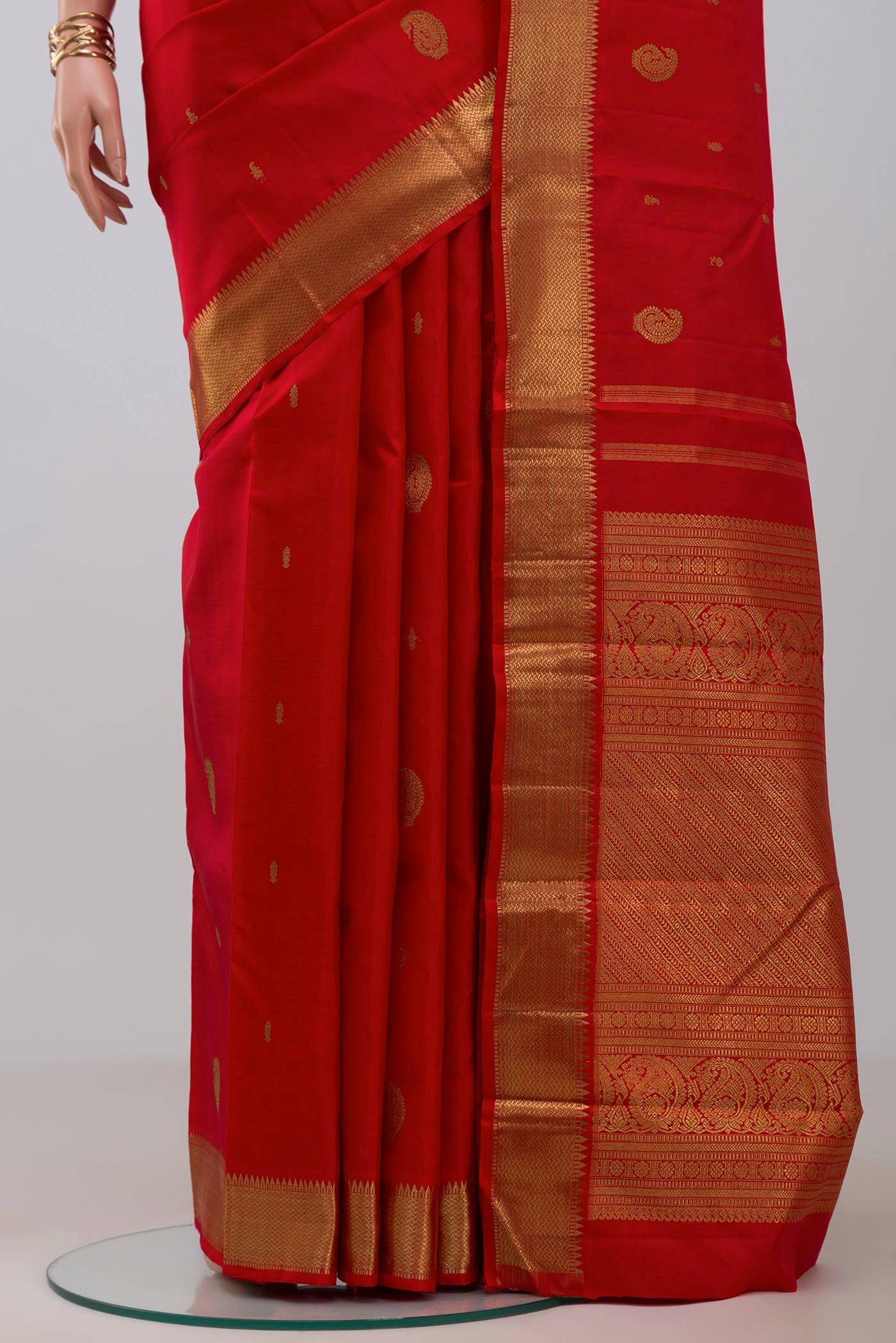 Pleats and pallu of Pure Silk Pure Zari Red Kanchipuram Saree with Zari Butta on the body and Zari Border. 