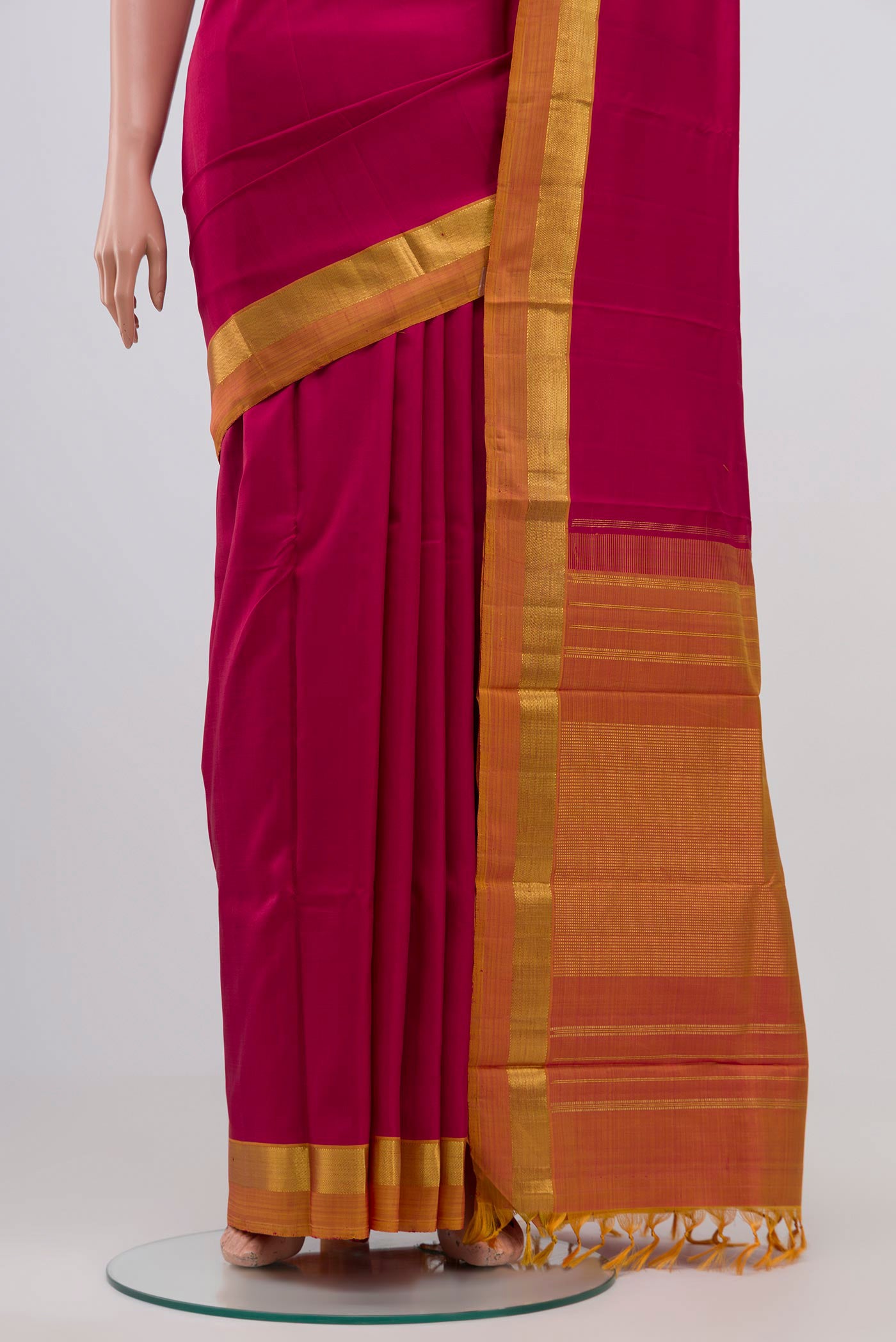 Pleats and pallu of Maroon Kanjivaram Silk Saree with Plain Body and Zari Border. 