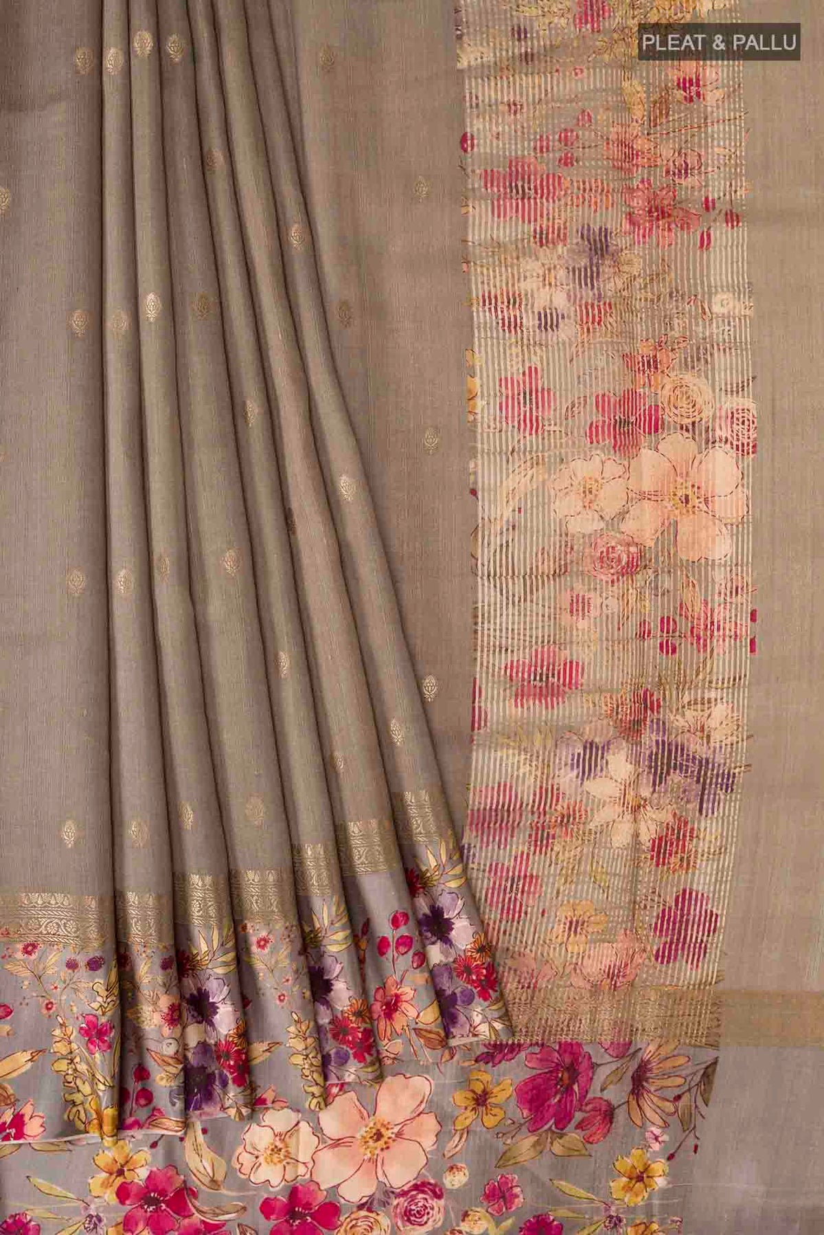 Pleats and pallu of Grey Tussar Silk Saree with Zari Butta on the body and Printed Border