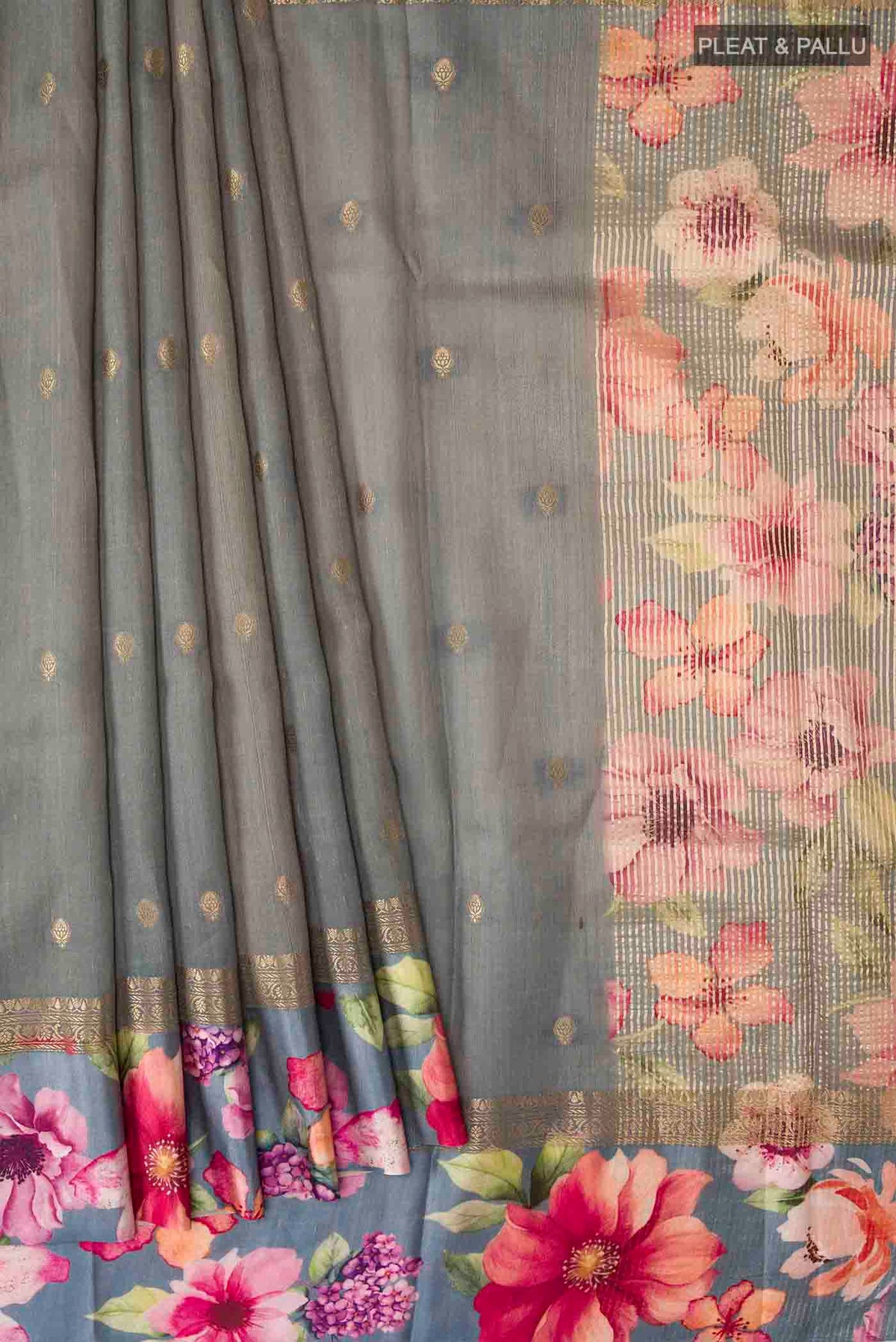 Pleats and pallu of Grey Tussar Silk Saree with Zari Butta on the body and Printed Border