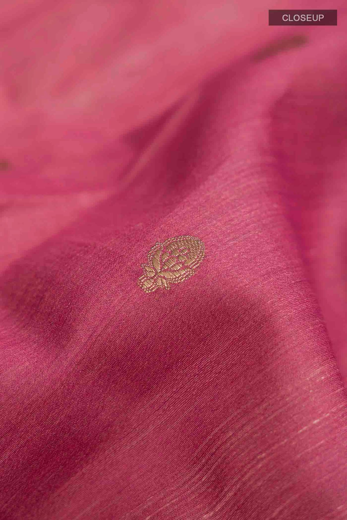 Close up of Mauve Tussar Silk Saree with Zari Butta on the body and Printed Border displaying folds