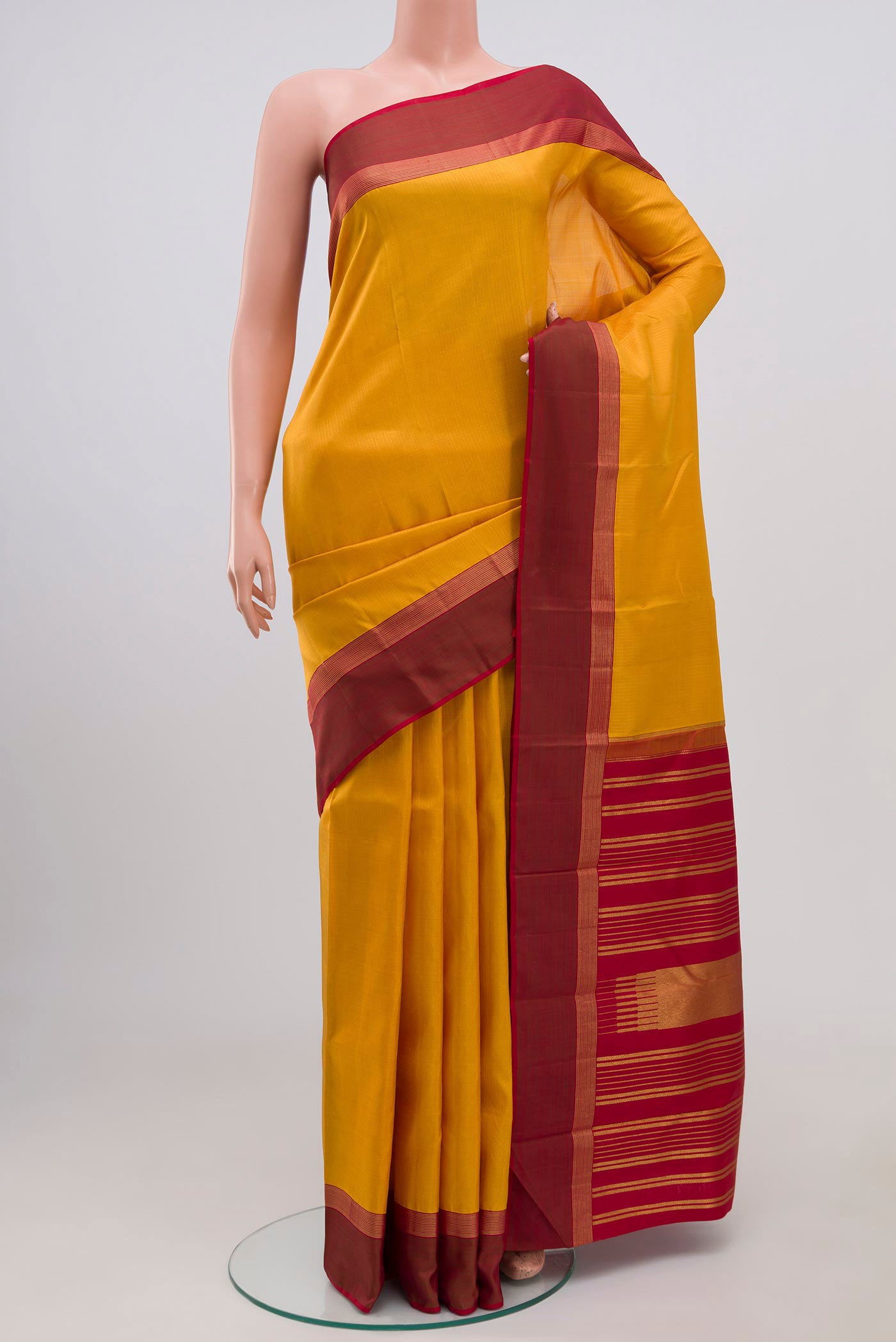 Pure Silk Pure Zari Yellow Kanjivaram Saree with Stripes on the body and Thin Zari Line.  displayed on a mannequin