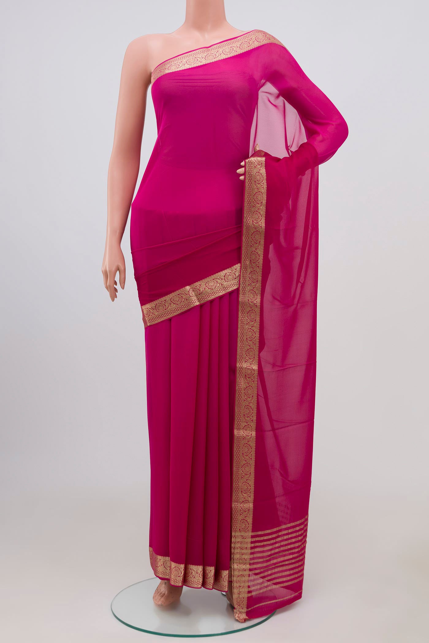 Pink Chiffon Saree with Plain Body and Zari Border.  displayed on a mannequin