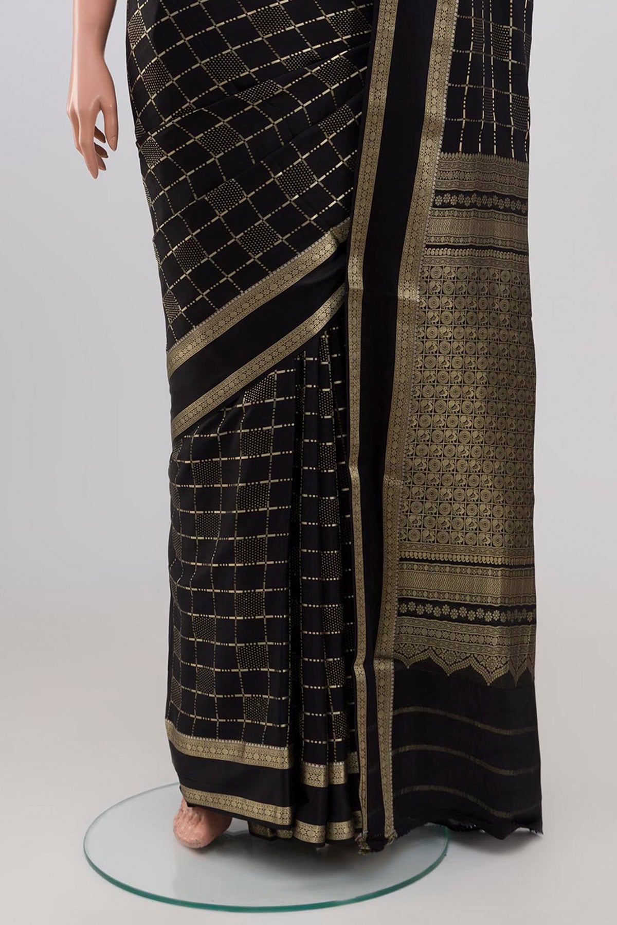 Pleats and pallu of Black Mysore Silk Saree with Checked design on the body and Zari Border. 