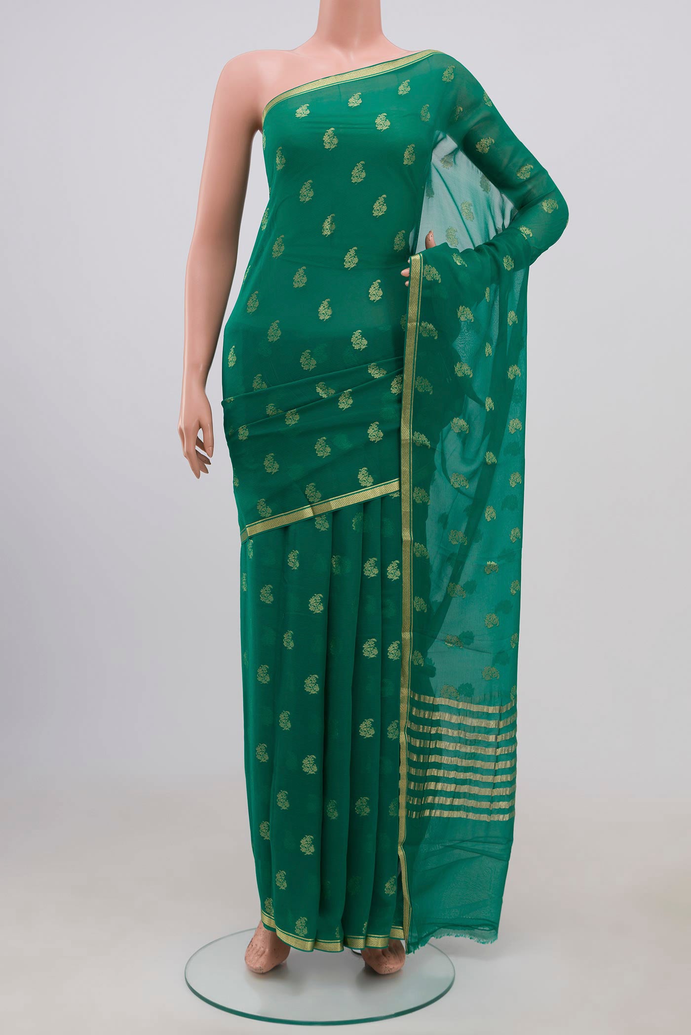 Green Chiffon Saree with Zari Brocade on the body and Zari Border.  displayed on a mannequin