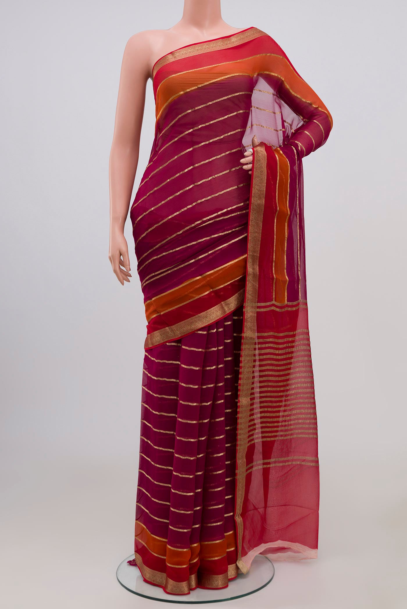 Magenta Chiffon Saree with Veldhari on the body and Zari Border.  displayed on a mannequin