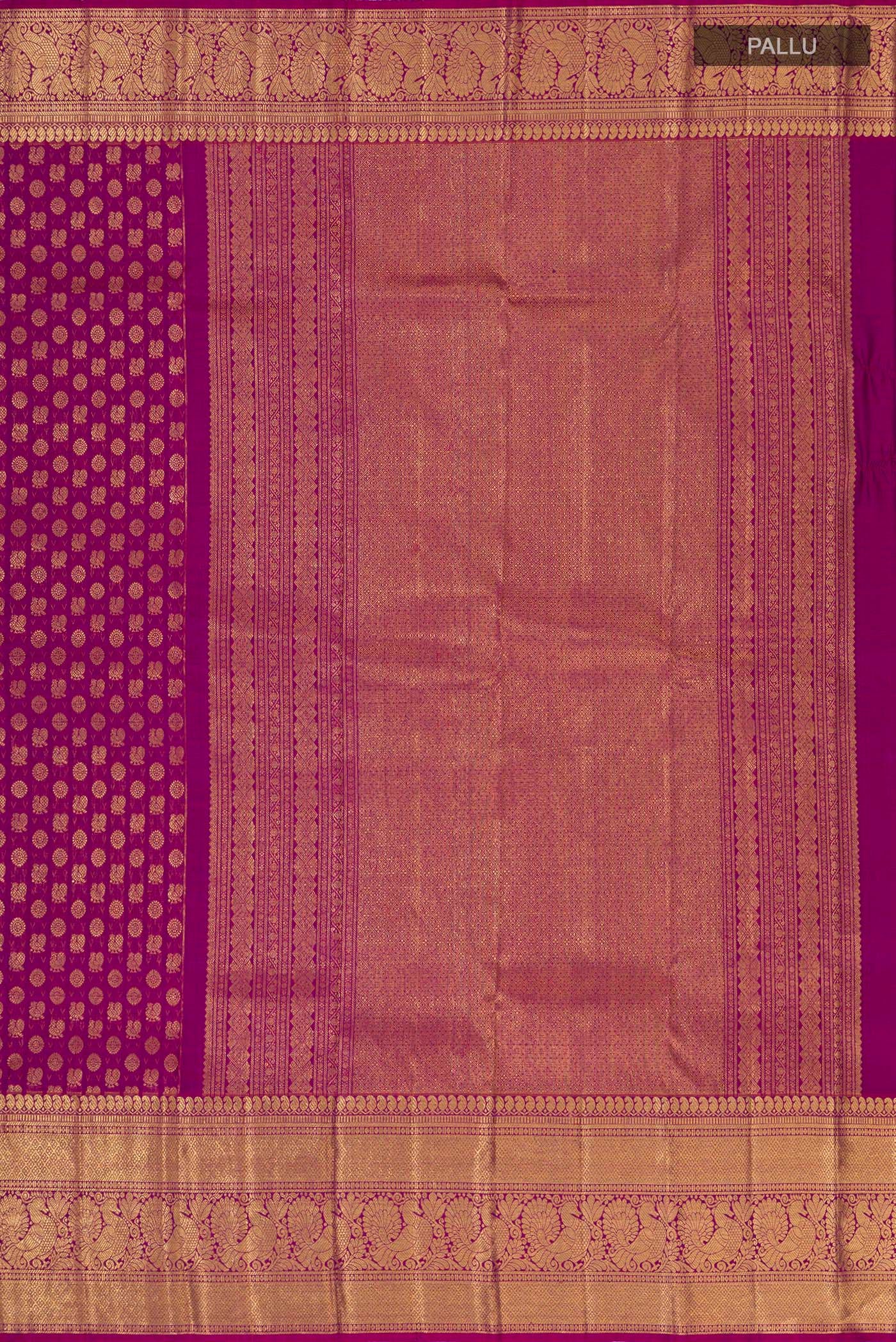 Close up image of the pallu of Magenta Kanchipuram Silk Saree with Zari Brocade on the body and Zari Border. 