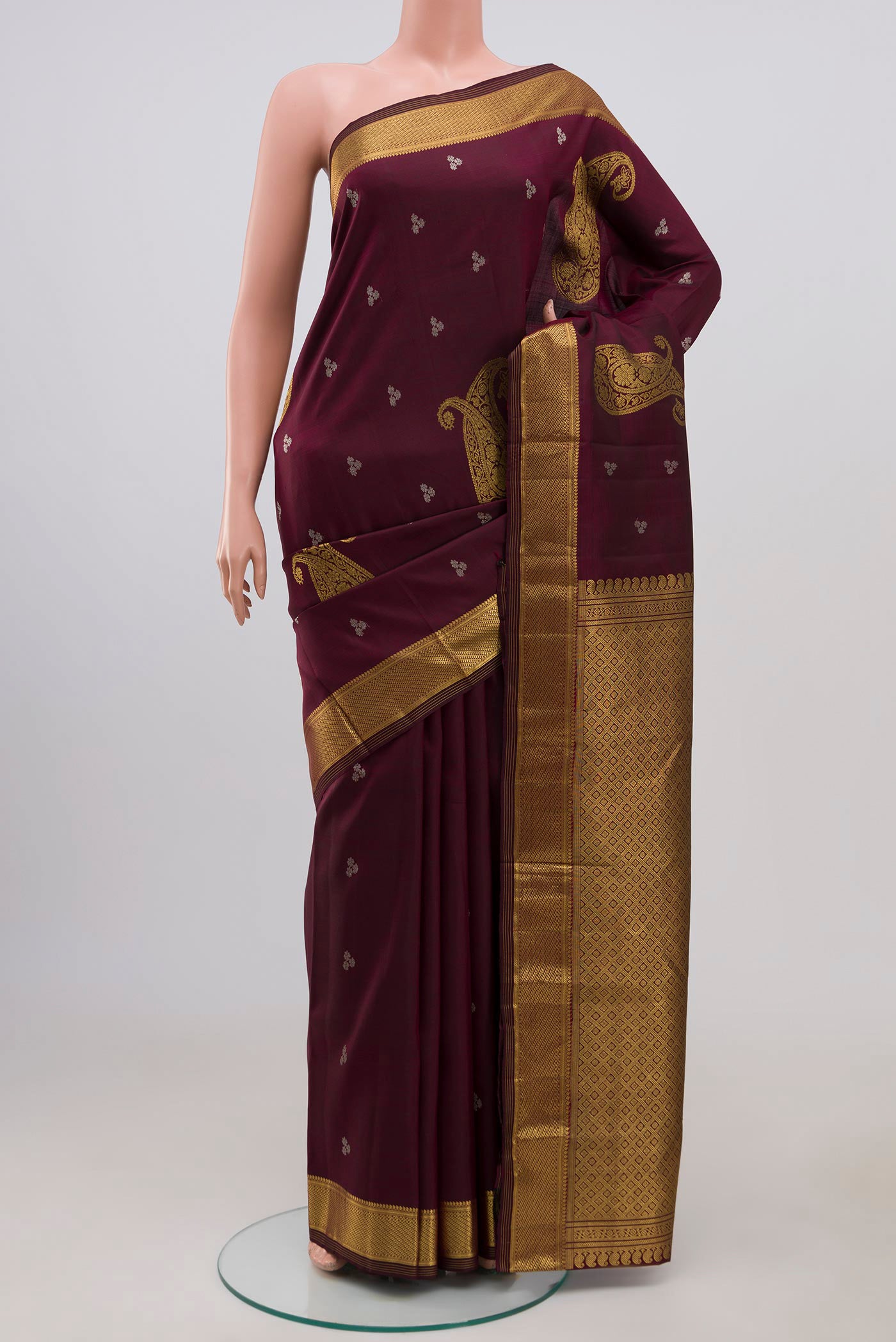 Brown Kanjivaram Silk Saree with Zari Butta on the body and Zari Border.  displayed on a mannequin