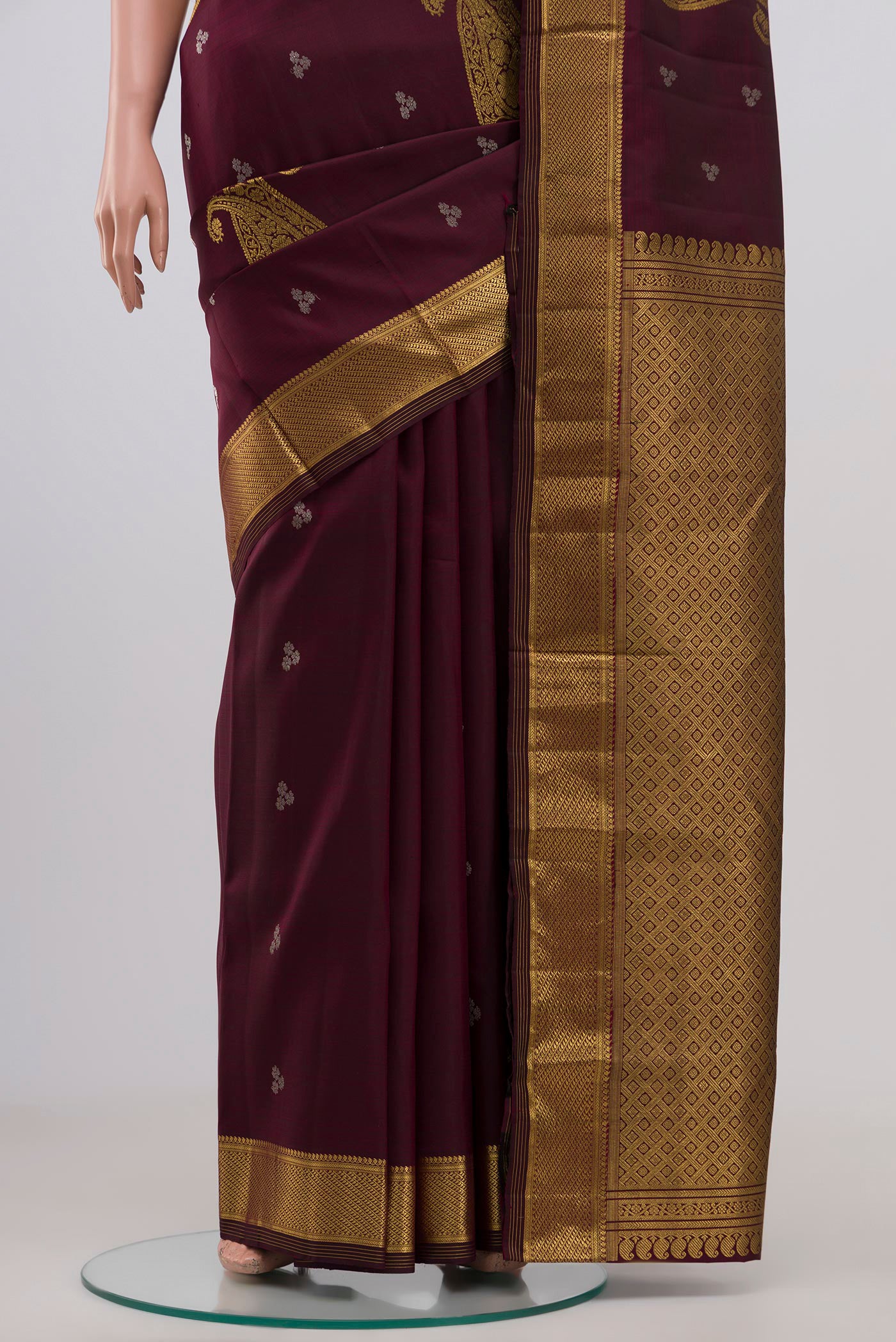 Pleats and pallu of Brown Kanjivaram Silk Saree with Zari Butta on the body and Zari Border. 