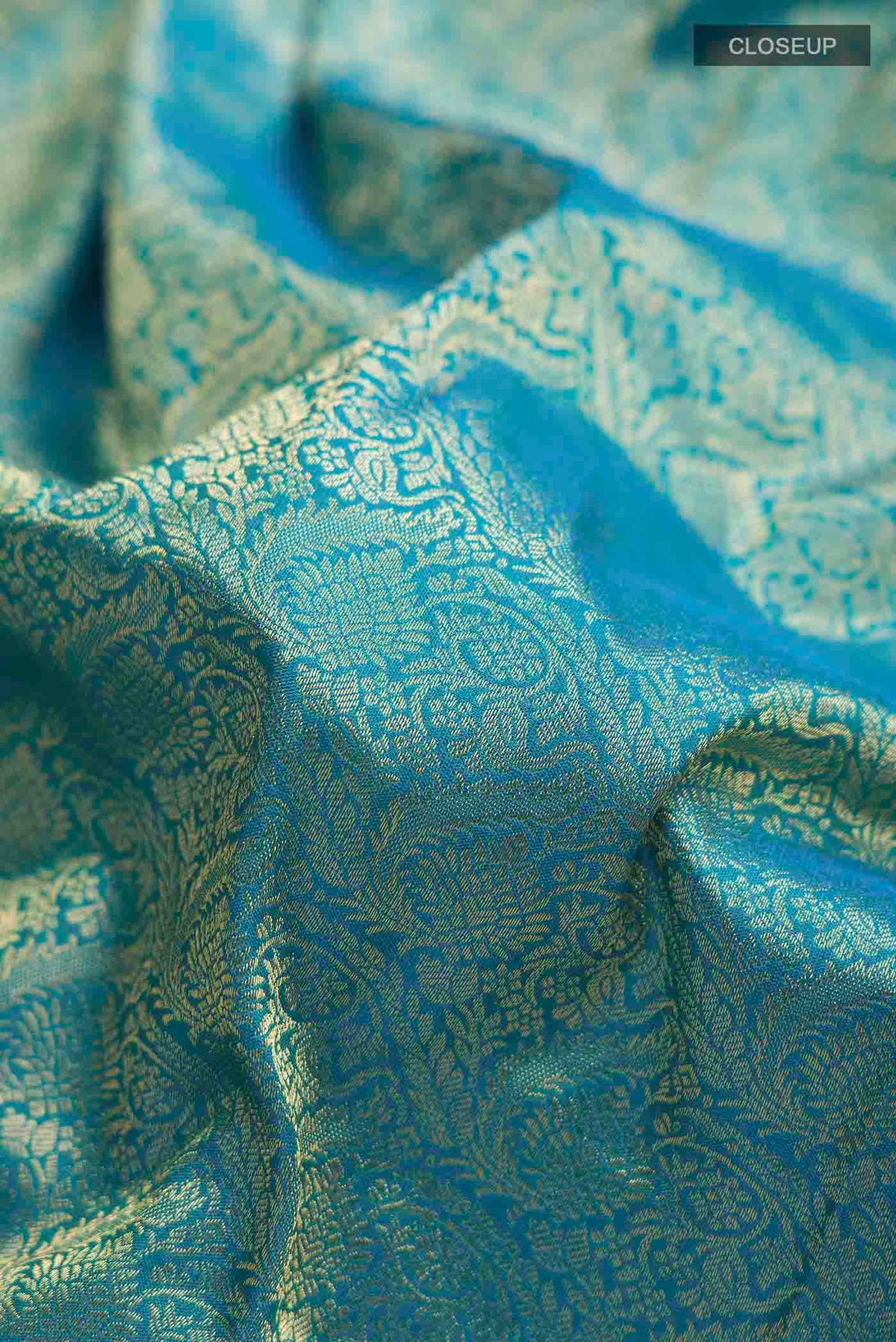 Close up of Blue Kanchipuram Silk Saree with Zari Brocade on the body and Zari Border displaying folds