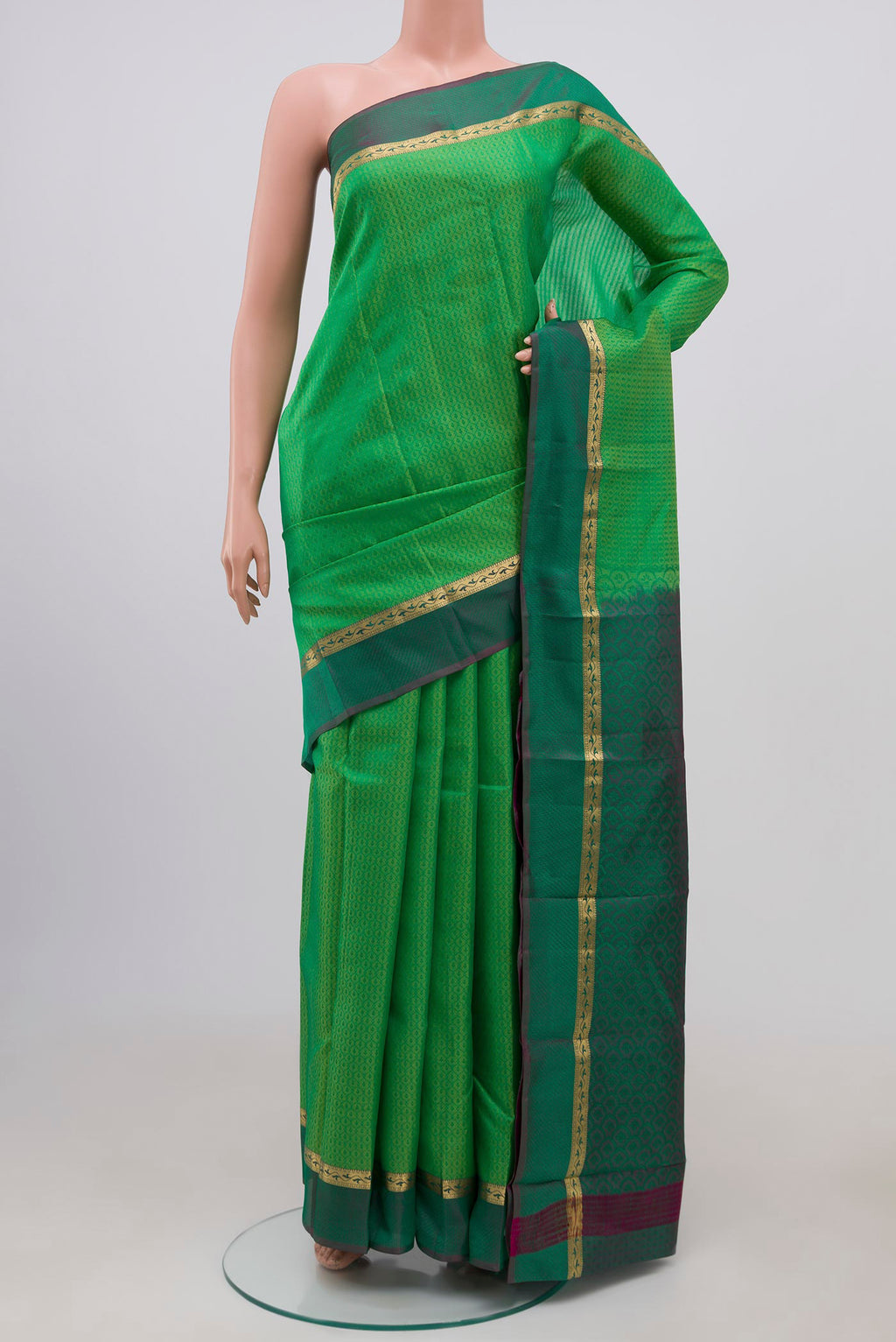 Light Green Kanchipuram Silk Saree with Jacquard design on the body and Thin Zari Line.  displayed on a mannequin
