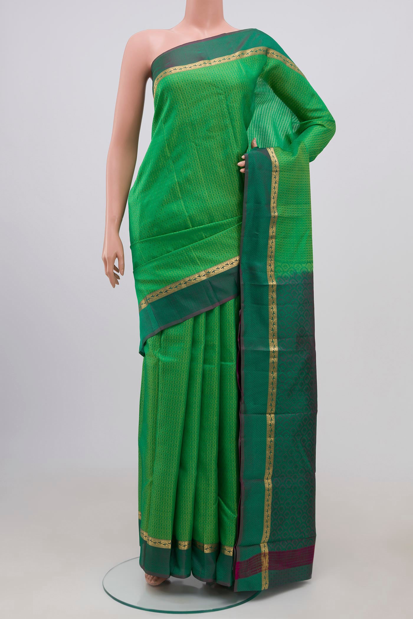 Light Green Kanchipuram Silk Saree with Jacquard design on the body and Thin Zari Line.  displayed on a mannequin