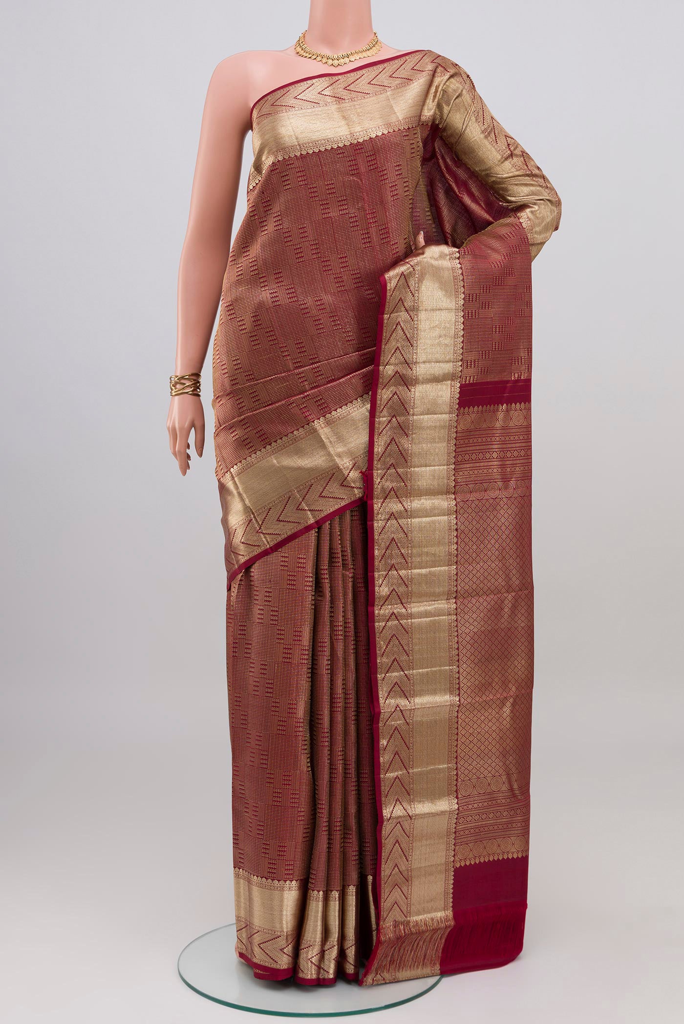 Maroon Kanchipuram Silk Saree with Zari Brocade on the body and Zari Border.  displayed on a mannequin