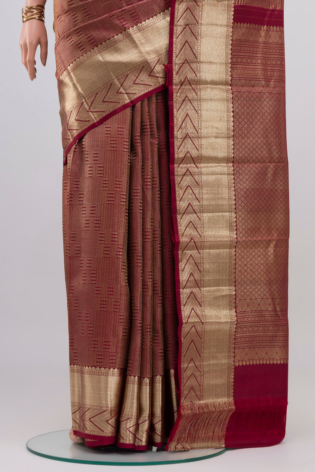 Pleats and pallu of Maroon Kanchipuram Silk Saree with Zari Brocade on the body and Zari Border. 