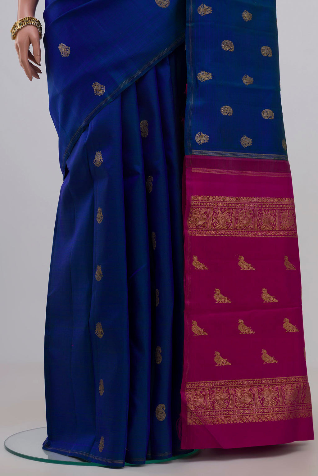 Pleats and pallu of Pure Silk Pure Zari Blue Kanchipuram Saree with Zari Butta on the body and Thin Zari Line. 