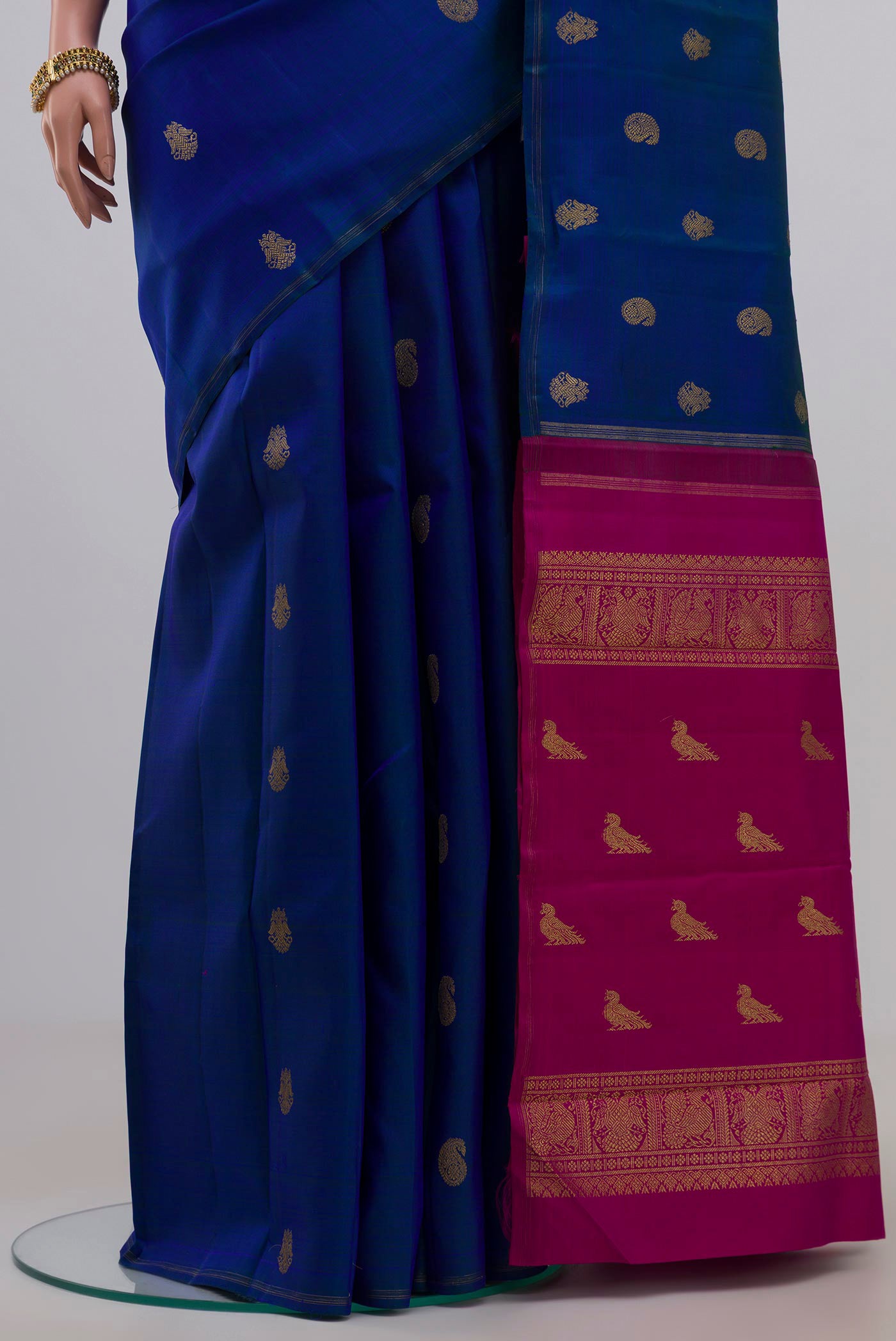 Pleats and pallu of Pure Silk Pure Zari Blue Kanchipuram Saree with Zari Butta on the body and Thin Zari Line. 