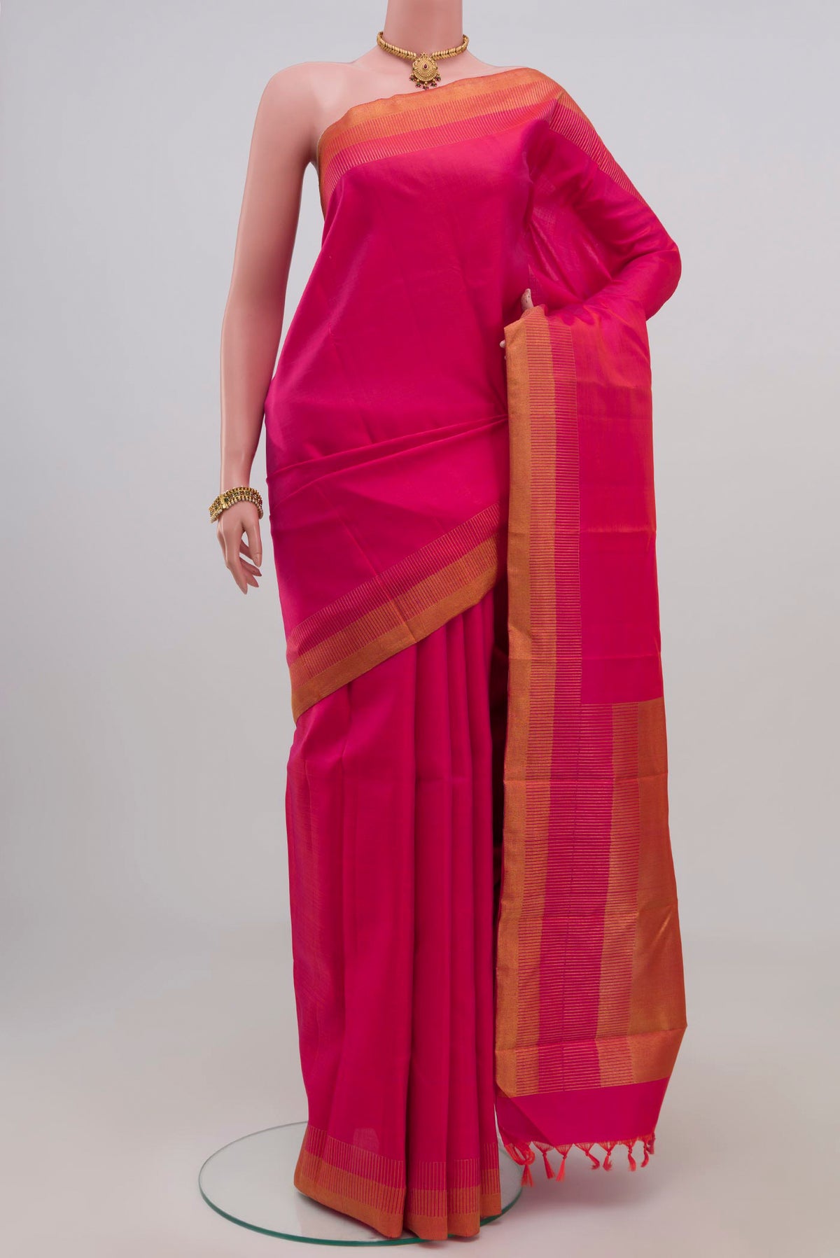 Pure Silk Pure Zari Pink Kanchipuram Saree with Plain Body and Zari Border.  displayed on a mannequin