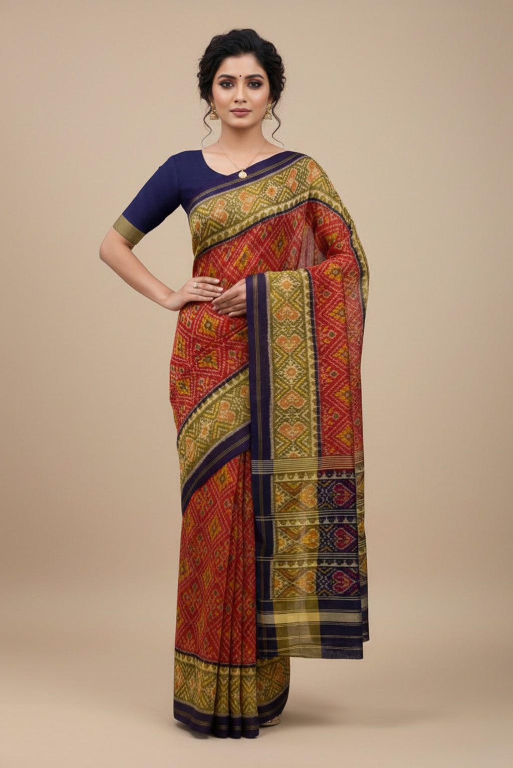 Model wearing a Red Rajkot Patola Silk Saree with Ikat design on the body and Thin Zari Line