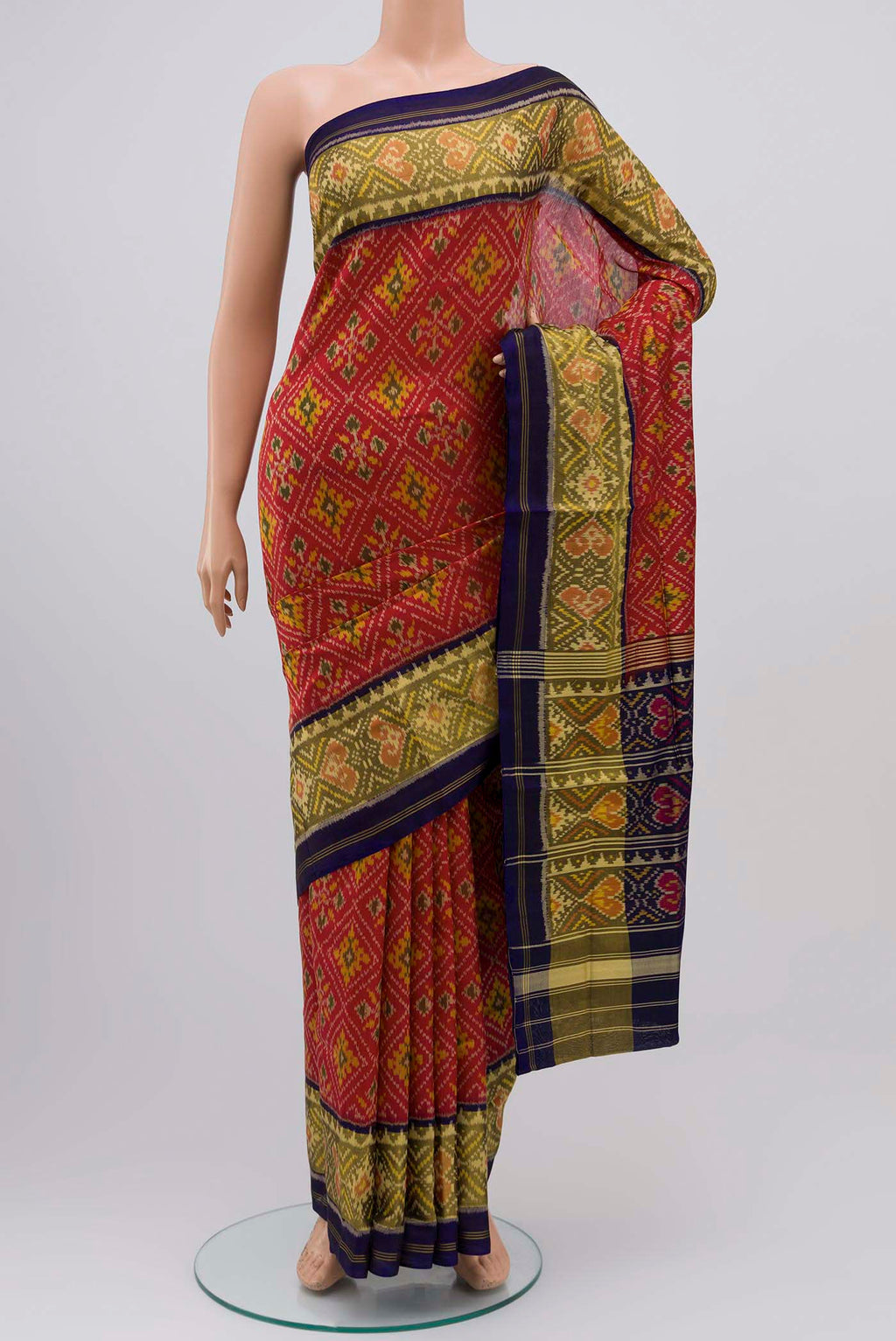Red Rajkot Patola Silk Saree with Ikat design on the body and Thin Zari Line displayed on a mannequin