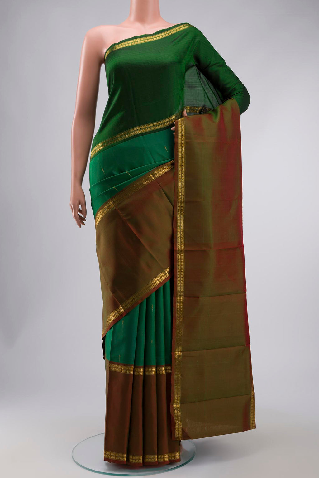 Green Kanchipuram Silk Saree with Zari Butta on the body and Zari Border displayed on a mannequin