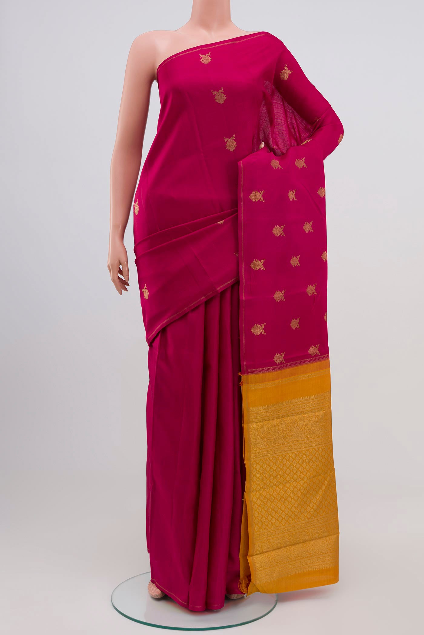 Pure Silk Pure Zari Pink Kanchipuram Saree with Zari Butta on the body and Thin Zari Line.  displayed on a mannequin