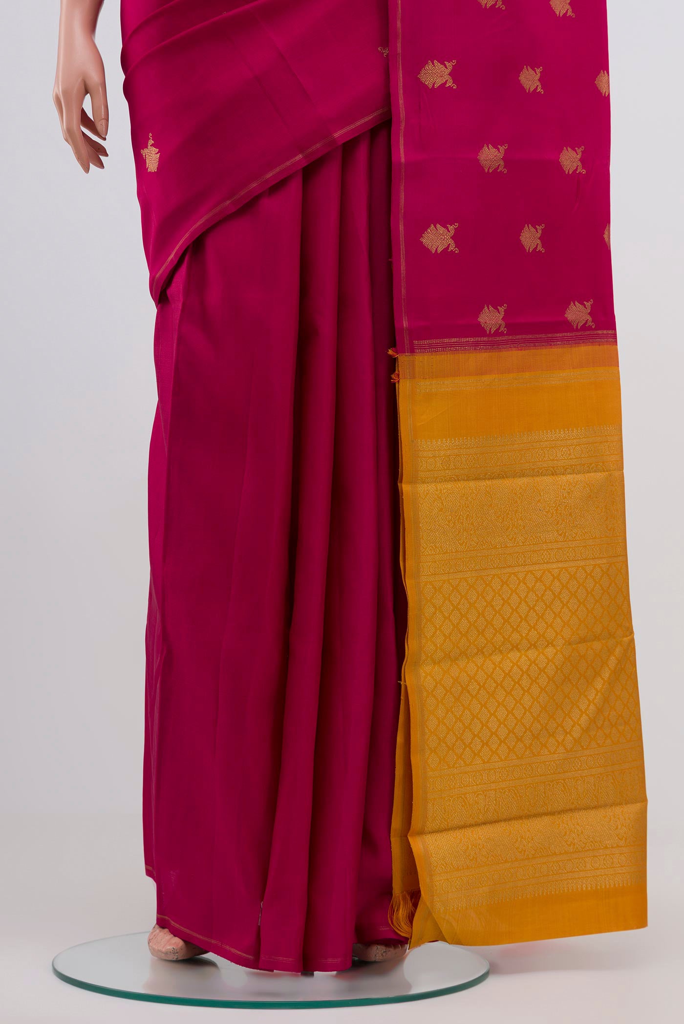 Pleats and pallu of Pure Silk Pure Zari Pink Kanchipuram Saree with Zari Butta on the body and Thin Zari Line. 