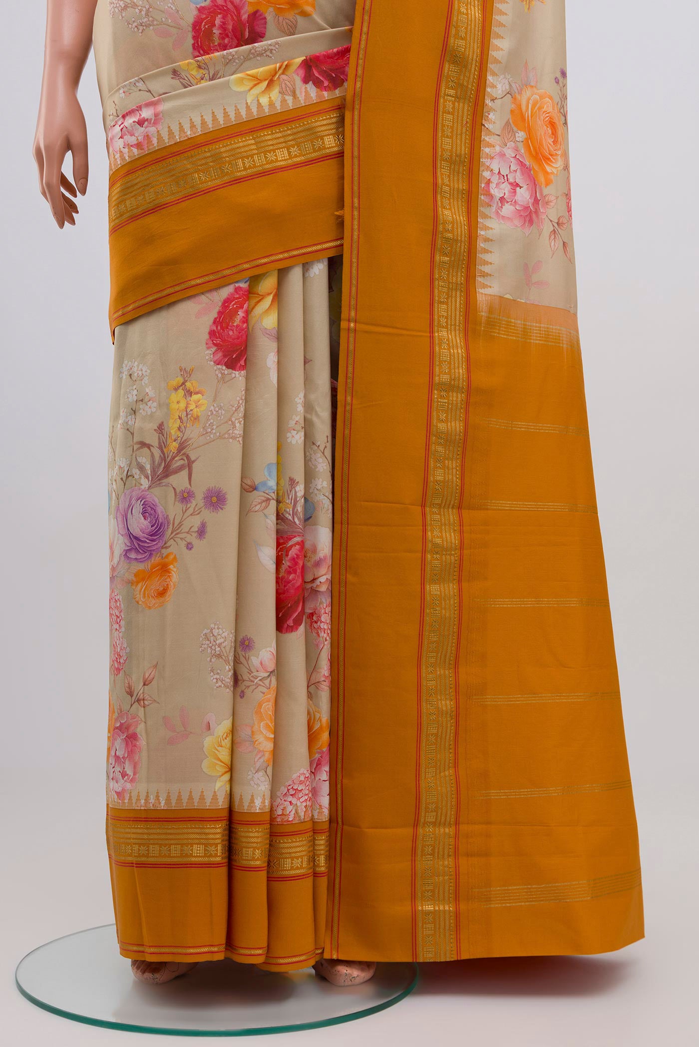 Pleats and pallu of Beige Printed Silk Saree with Printed design on the body and Zari Border. 