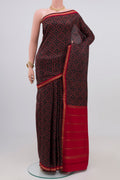 Black Printed Silk Saree with Printed design on the body and Zari Border.  displayed on a mannequin