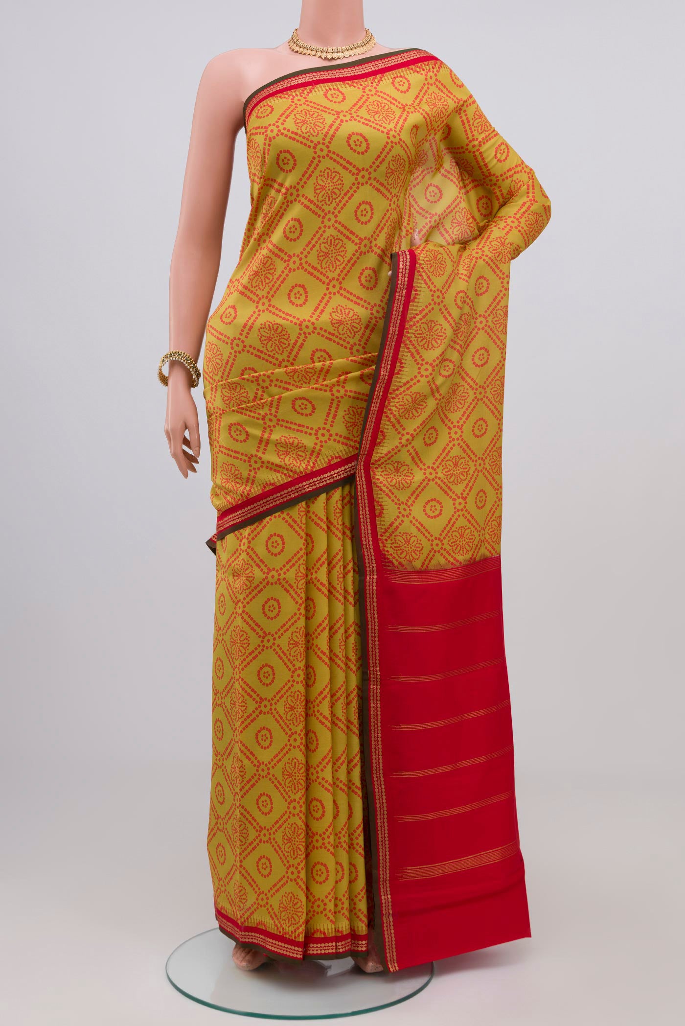 Yellow Printed Silk Saree with Printed design on the body and Zari Border.  displayed on a mannequin