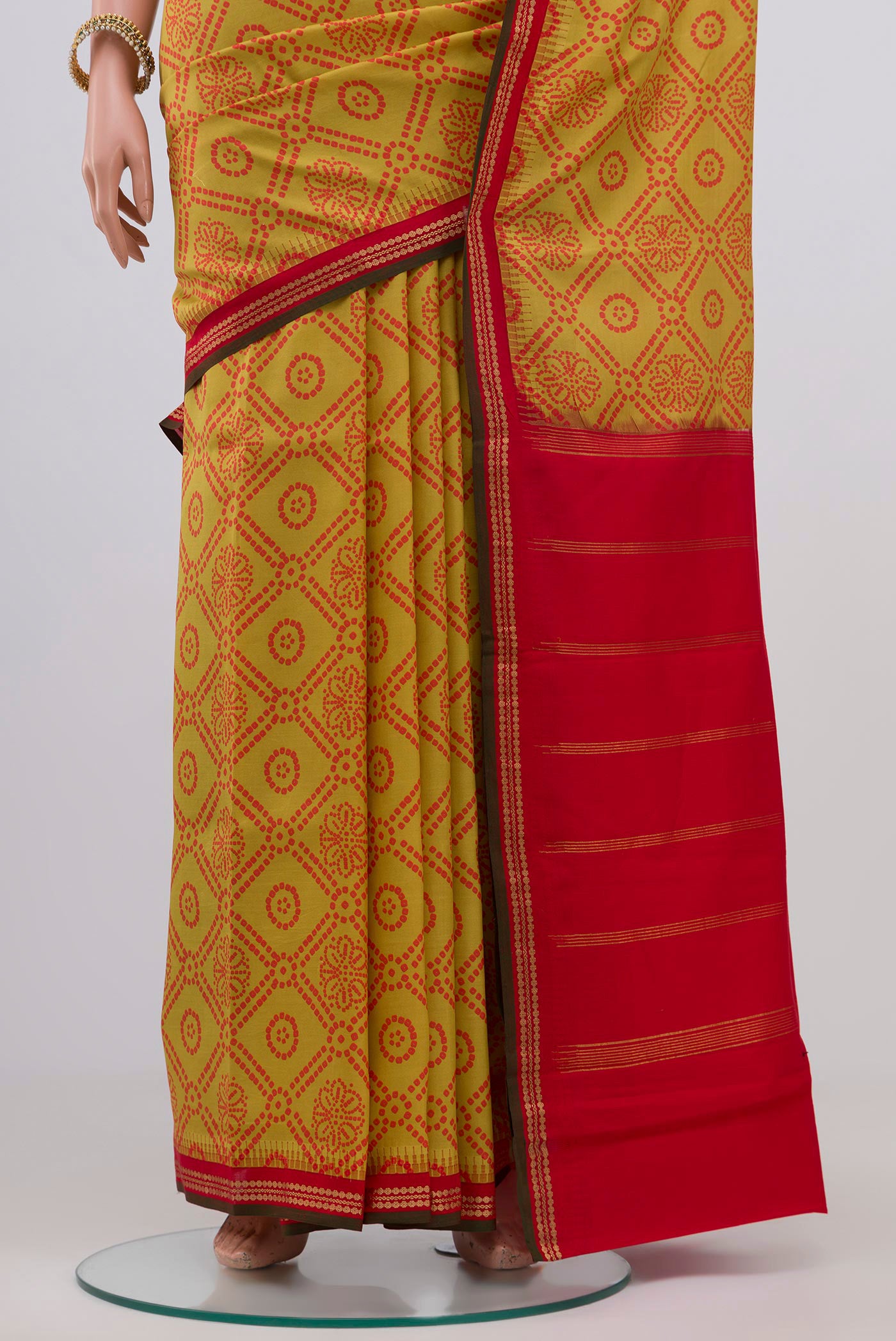 Pleats and pallu of Yellow Printed Silk Saree with Printed design on the body and Zari Border. 