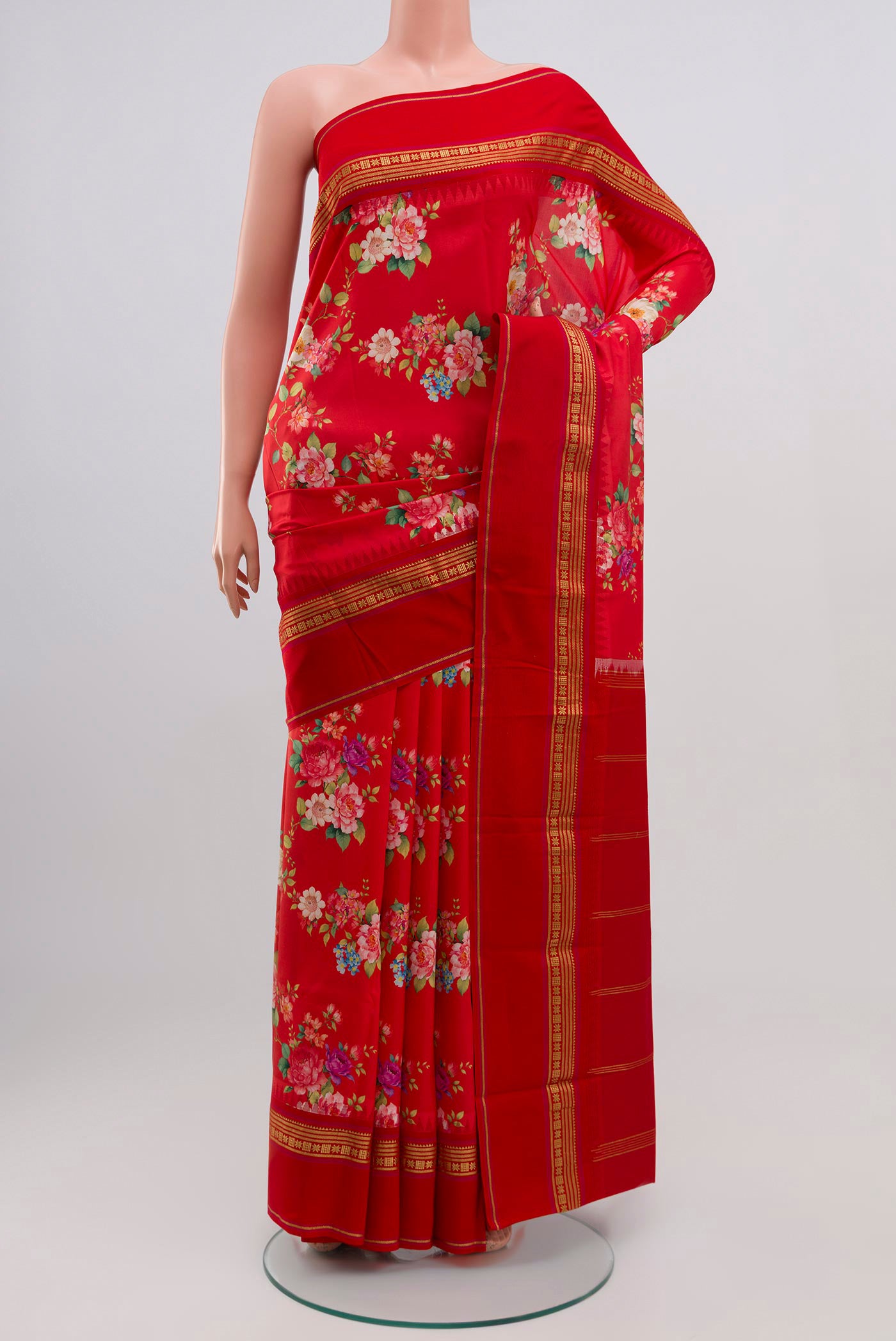 Red Printed Silk Saree with Printed design on the body and Zari Border.  displayed on a mannequin