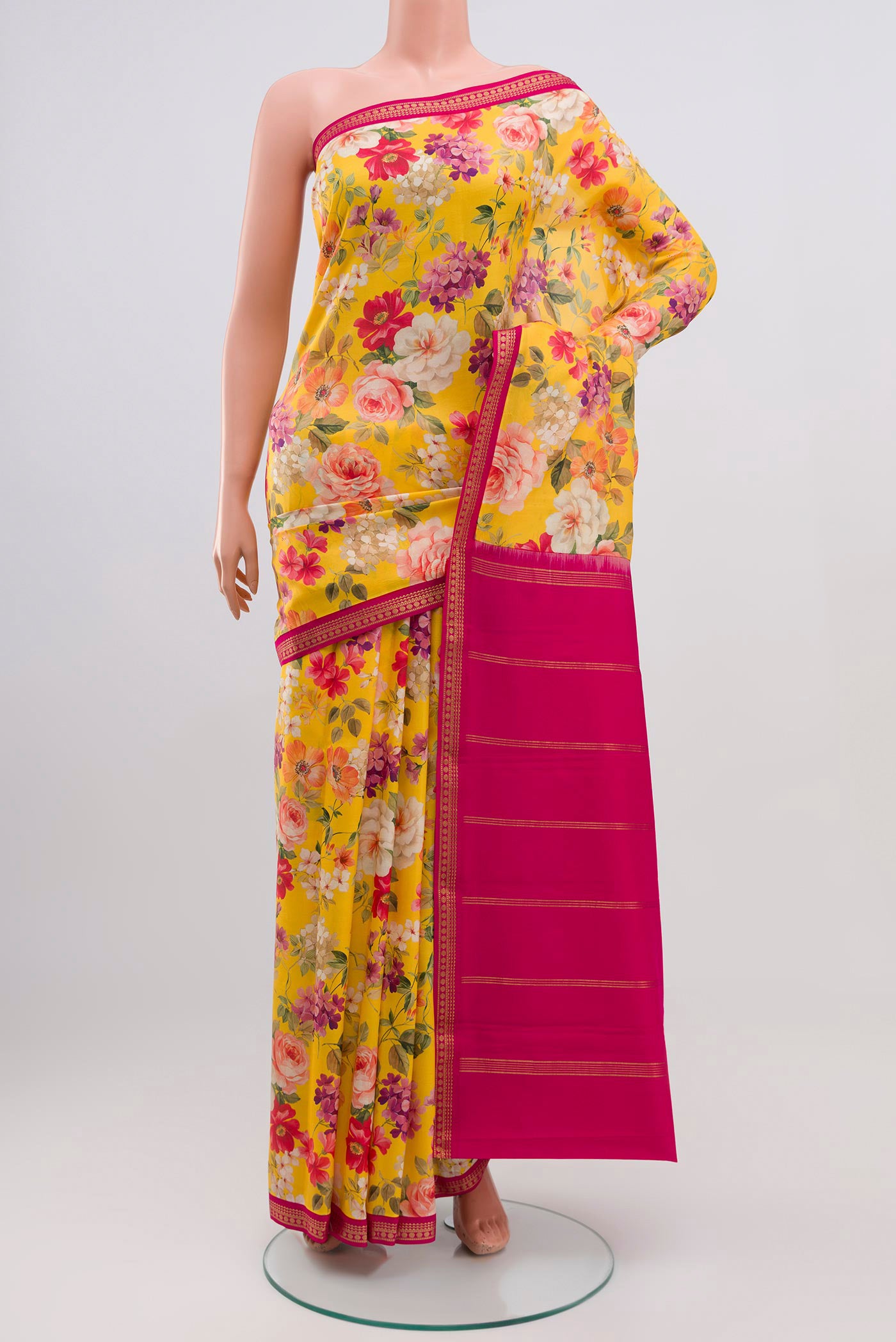 Yellow Printed Silk Saree with Fancy on the body and Zari Border.  displayed on a mannequin