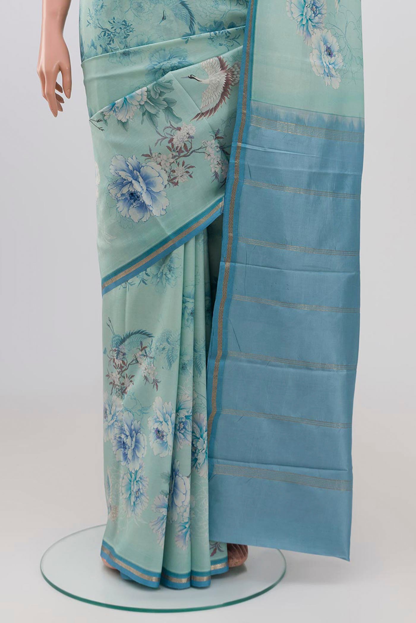 Pleats and pallu of Sky Blue Printed Silk Saree with Floral Print on the body and Zari Border. 
