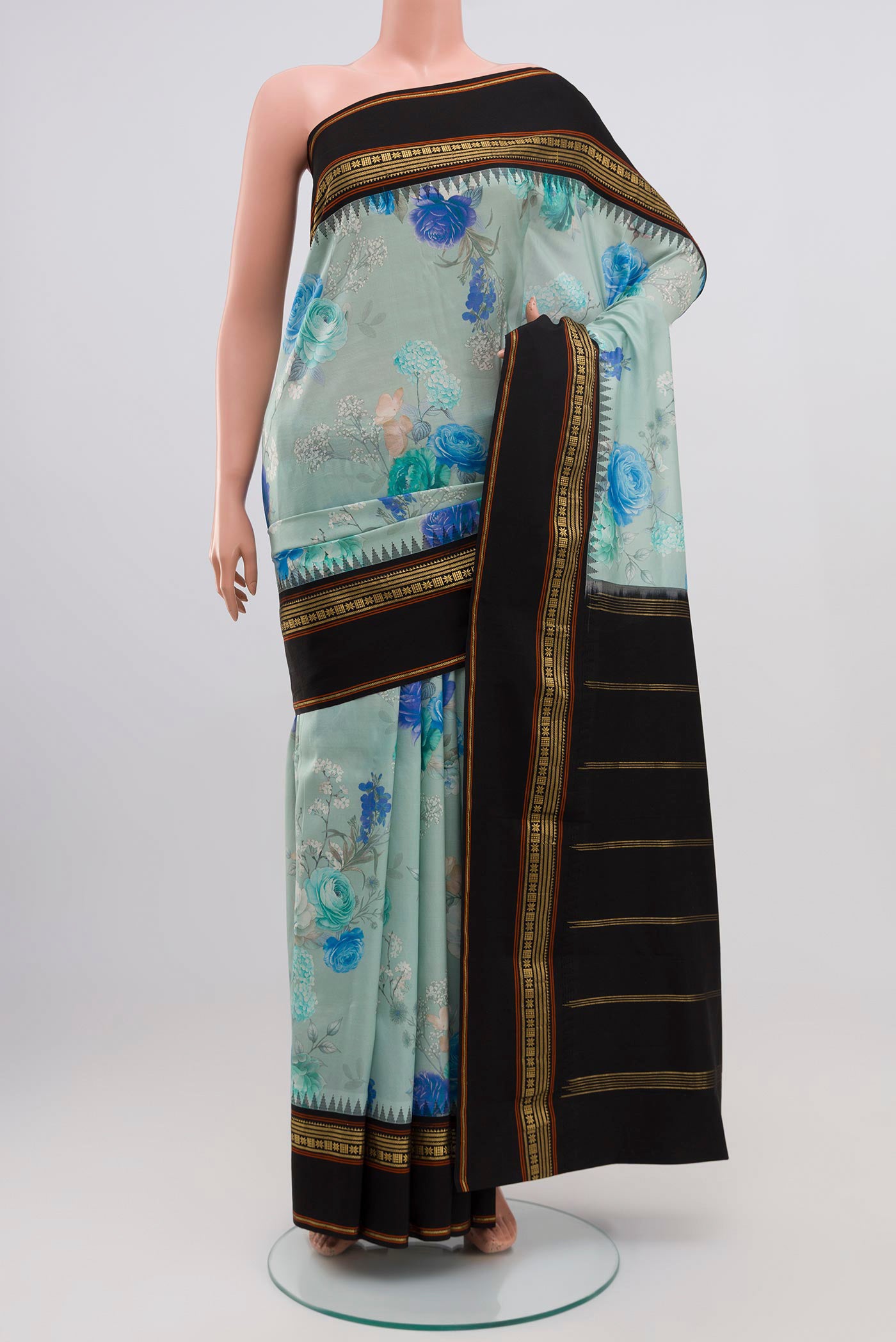 Sky Blue Printed Silk Saree with Fancy on the body and Zari Border.  displayed on a mannequin