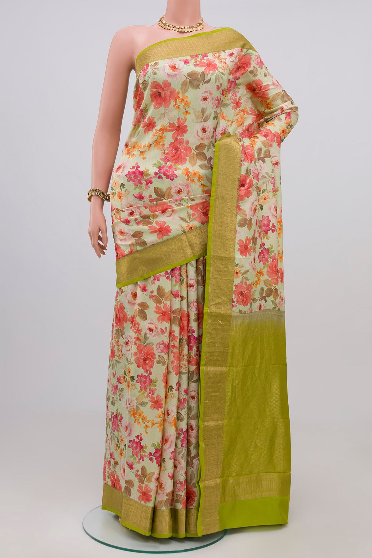 Light Green Printed Silk Saree with Printed design on the body and Zari Border.  displayed on a mannequin