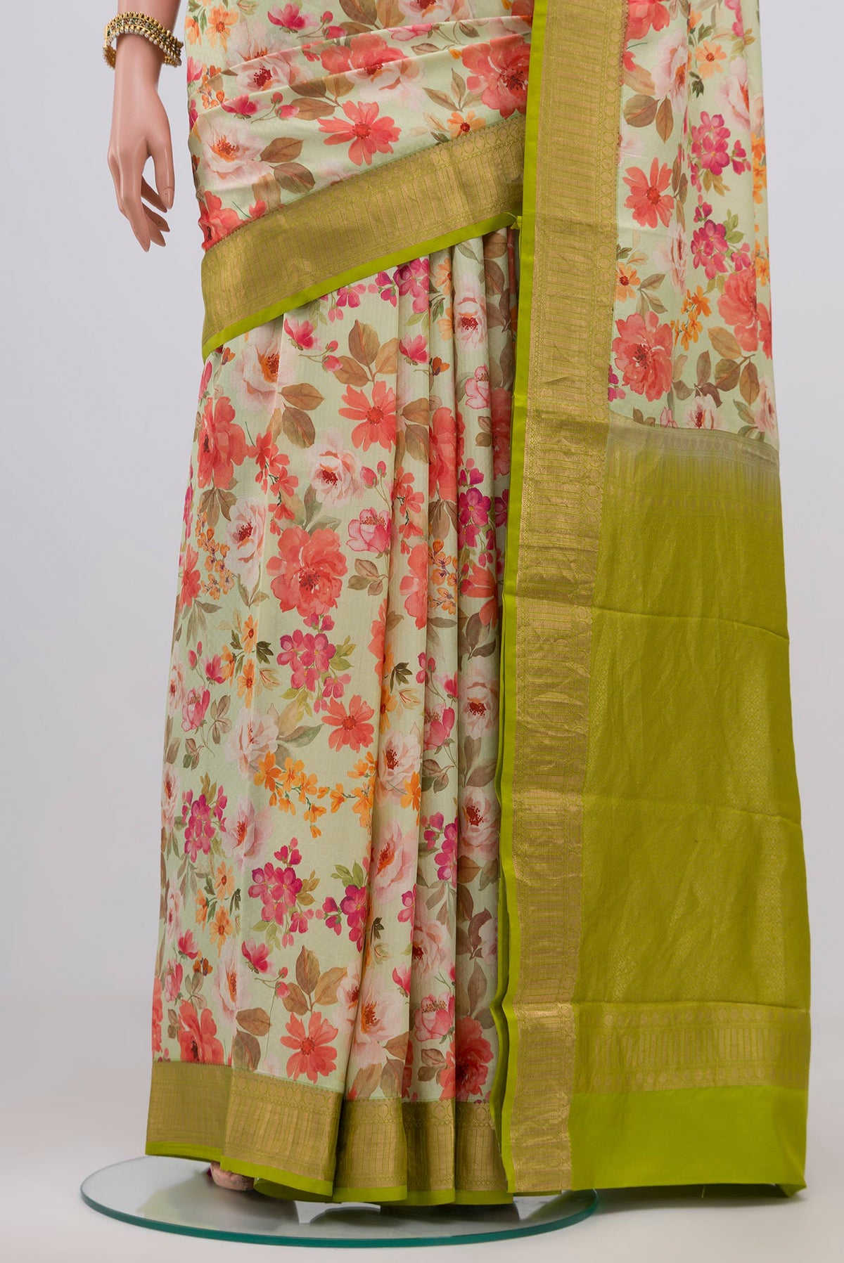 Pleats and pallu of Light Green Printed Silk Saree with Printed design on the body and Zari Border. 