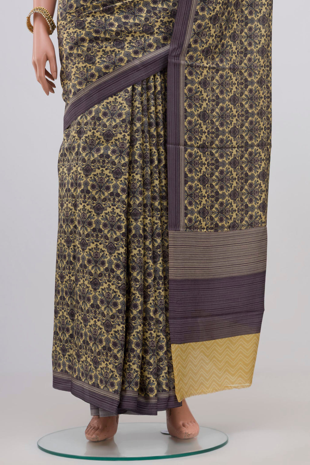 Pleats and pallu of Beige Printed Silk Saree with Printed design on the body and Plain Border. 