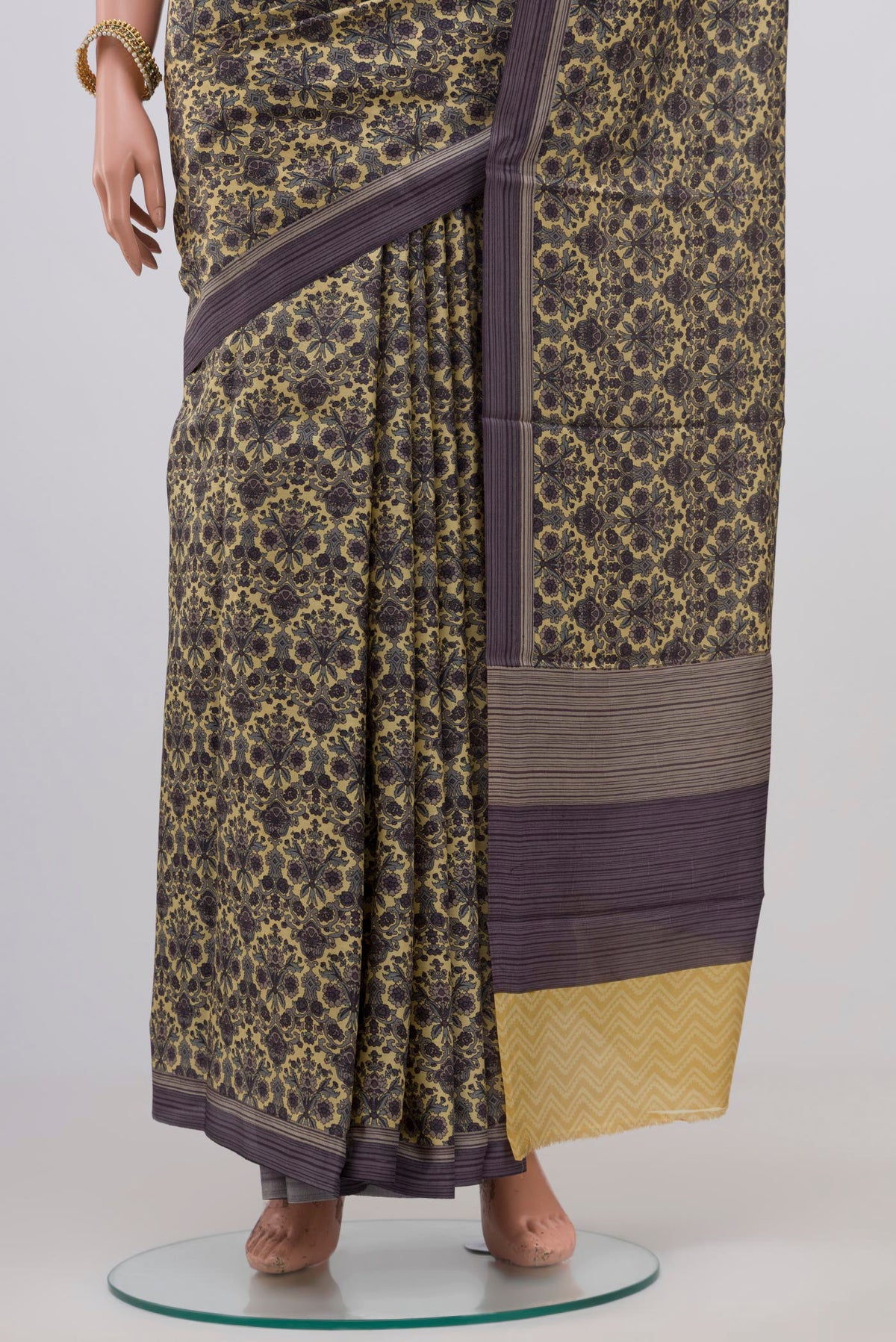 Pleats and pallu of Beige Printed Silk Saree with Printed design on the body and Plain Border. 