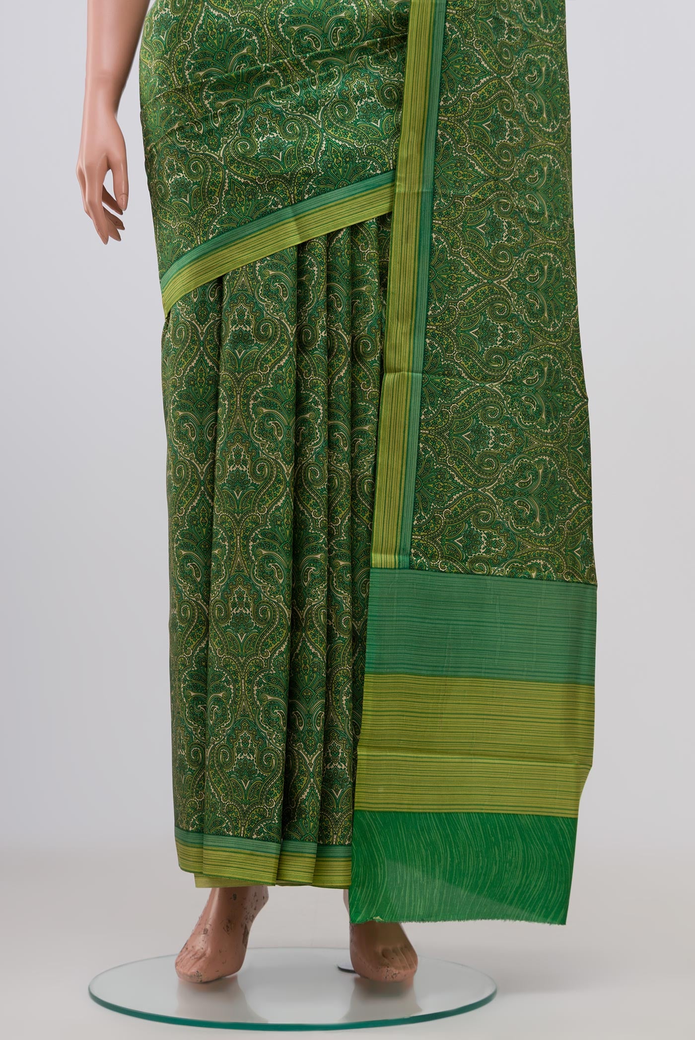 Pleats and pallu of Green Printed Silk Saree with Printed design on the body and Plain Border. 