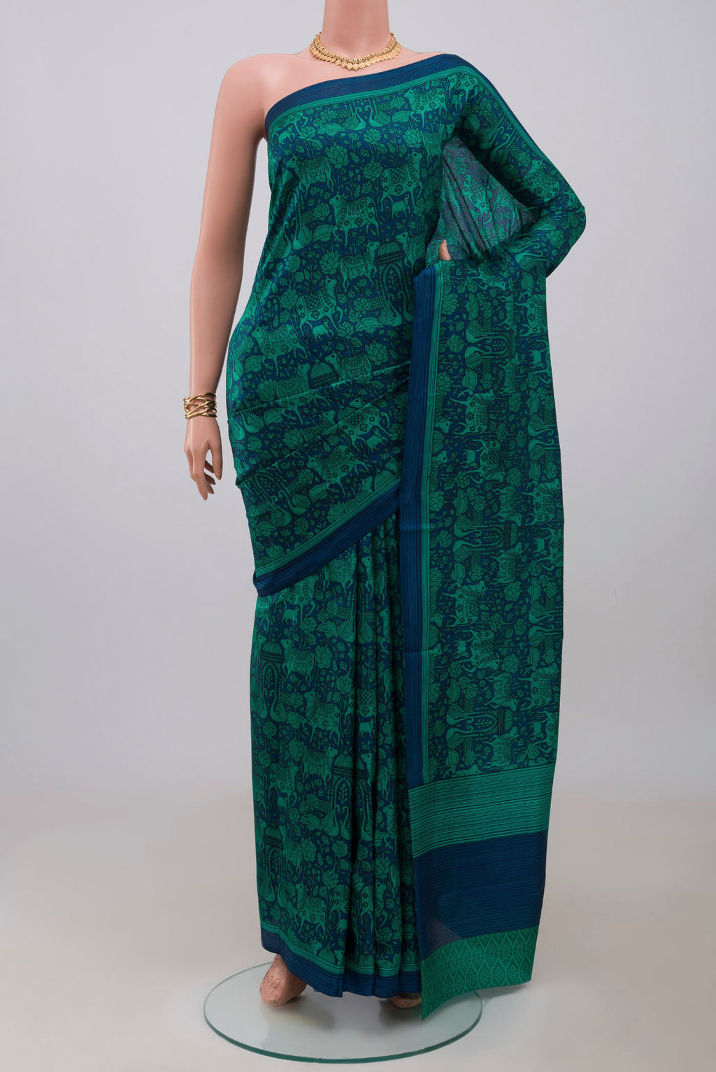 Navy Blue Printed Silk Saree with Printed design on the body and Plain Border.  displayed on a mannequin