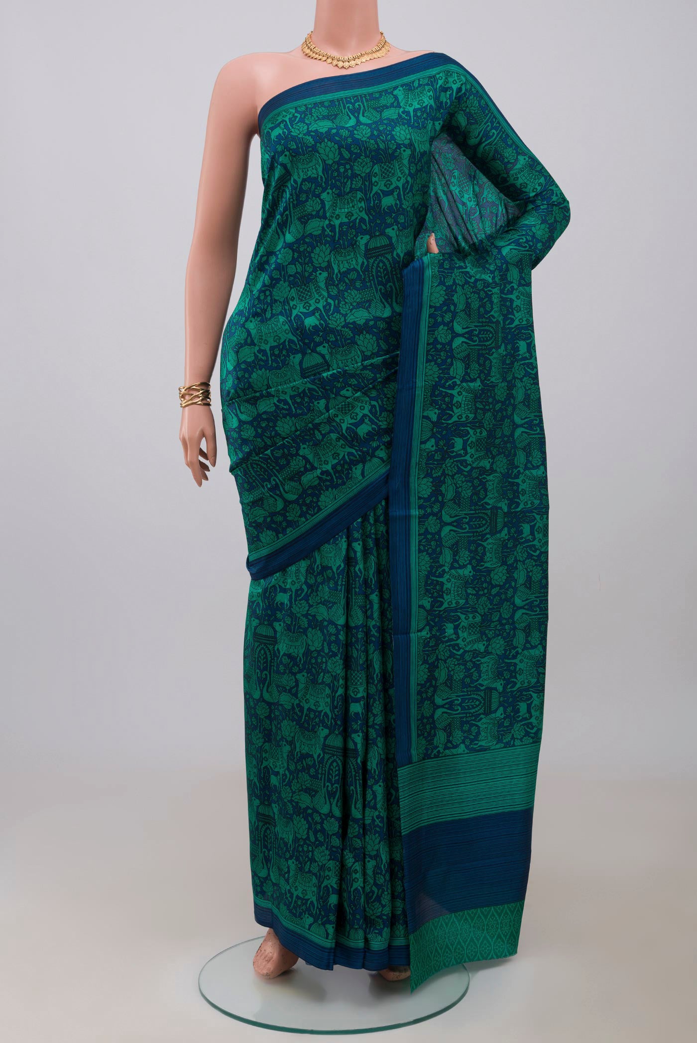 Navy Blue Printed Silk Saree with Printed design on the body and Plain Border.  displayed on a mannequin