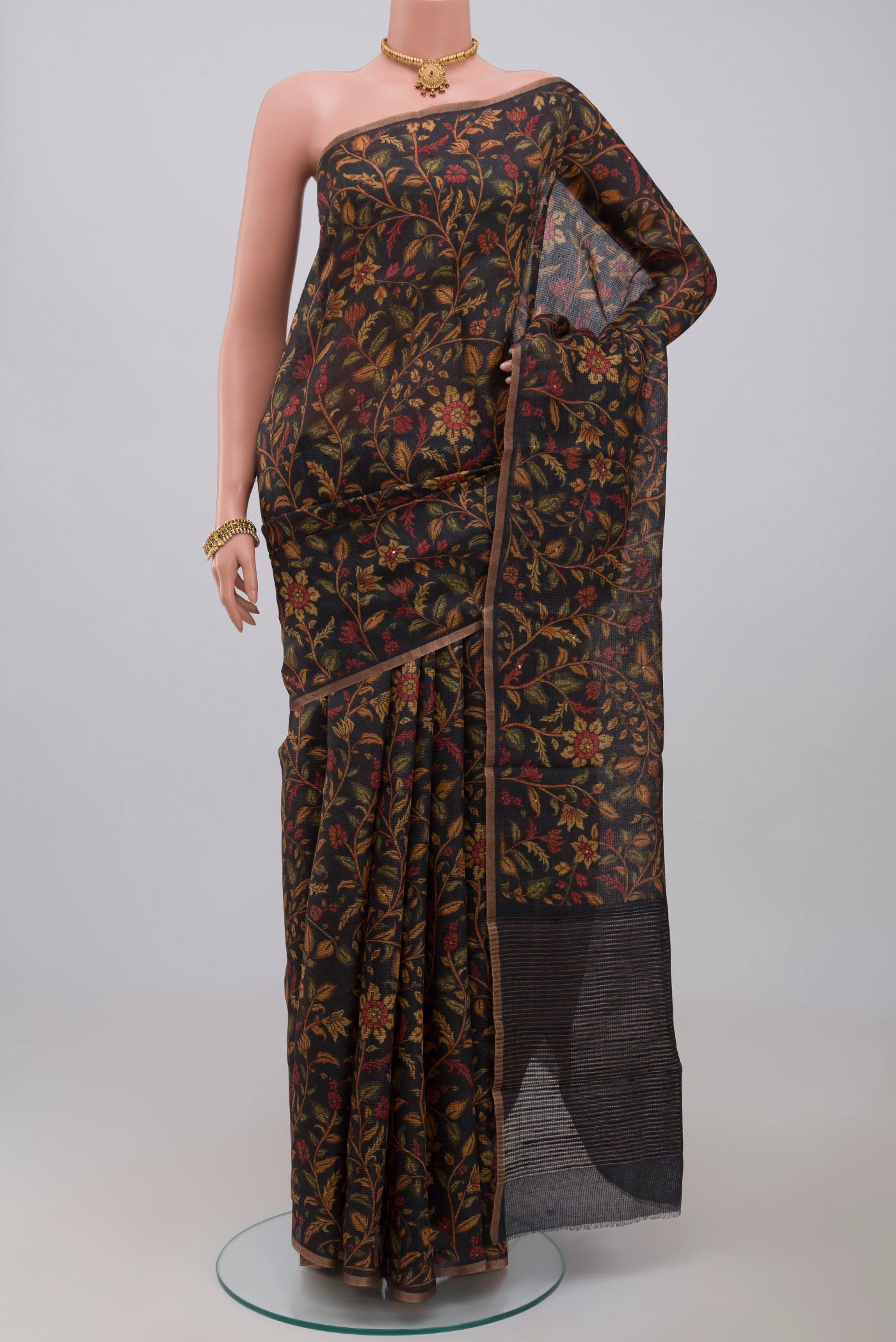 Black Tussar Silk Saree with Printed design on the body and Thin Zari Line.  displayed on a mannequin